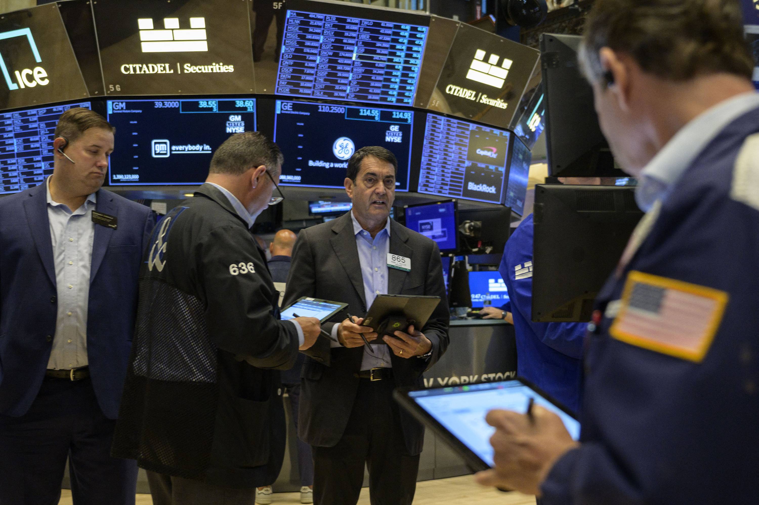 Traders work the floor of the New York Stock Exchange on July 25.