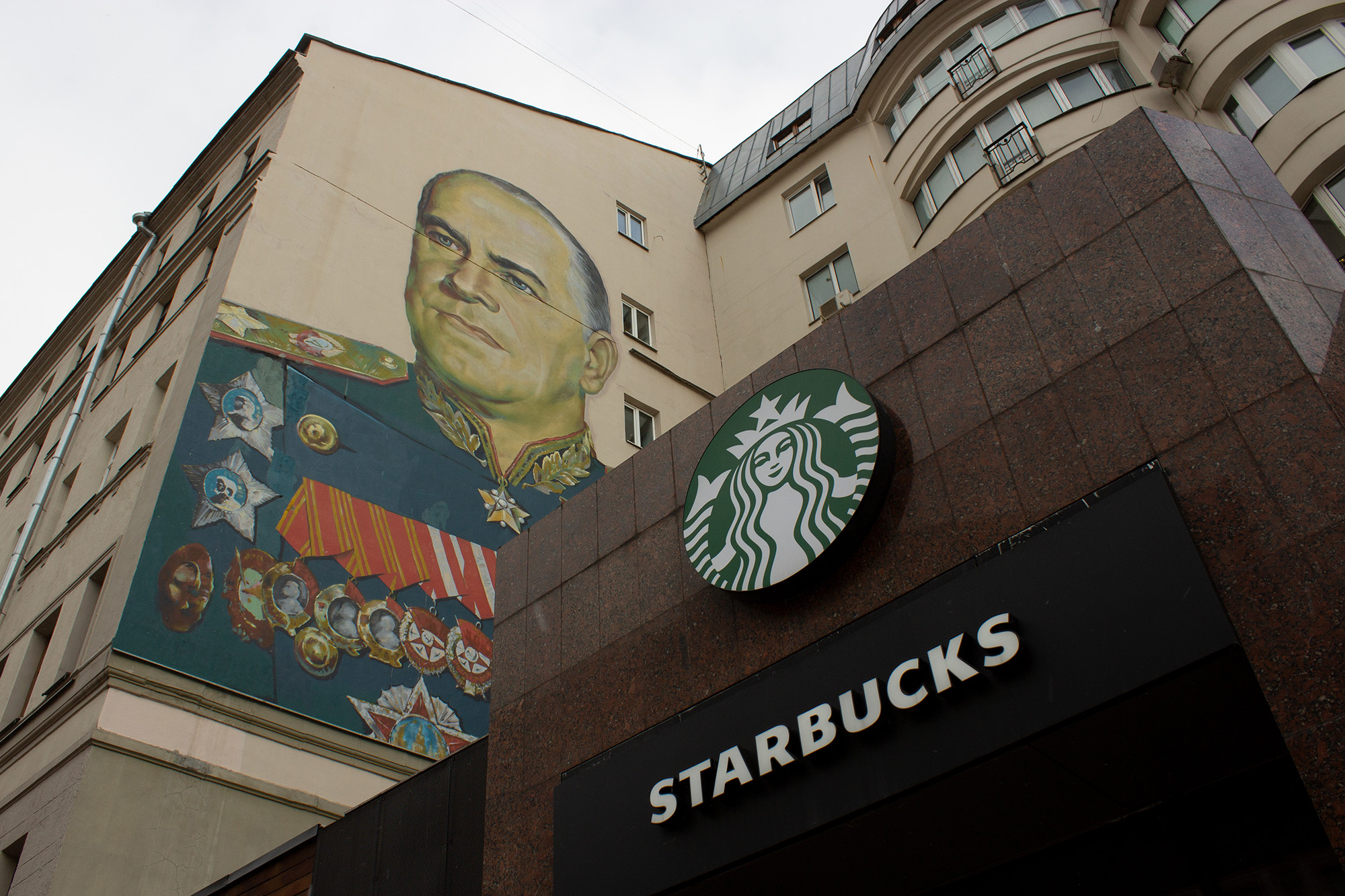 A Starbucks coffee shop alongside a mural of Georgy Zhukov, a Soviet general and Marshal of the Soviet Union, in Moscow, Russia, on March 27.