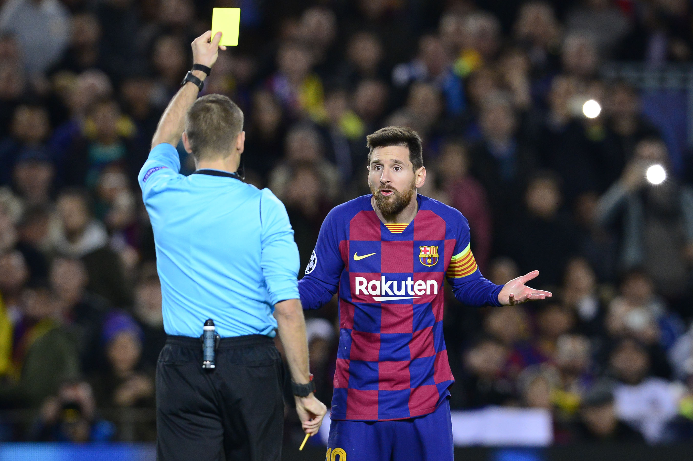 Lionel Messi reacts to his yellow card for diving.