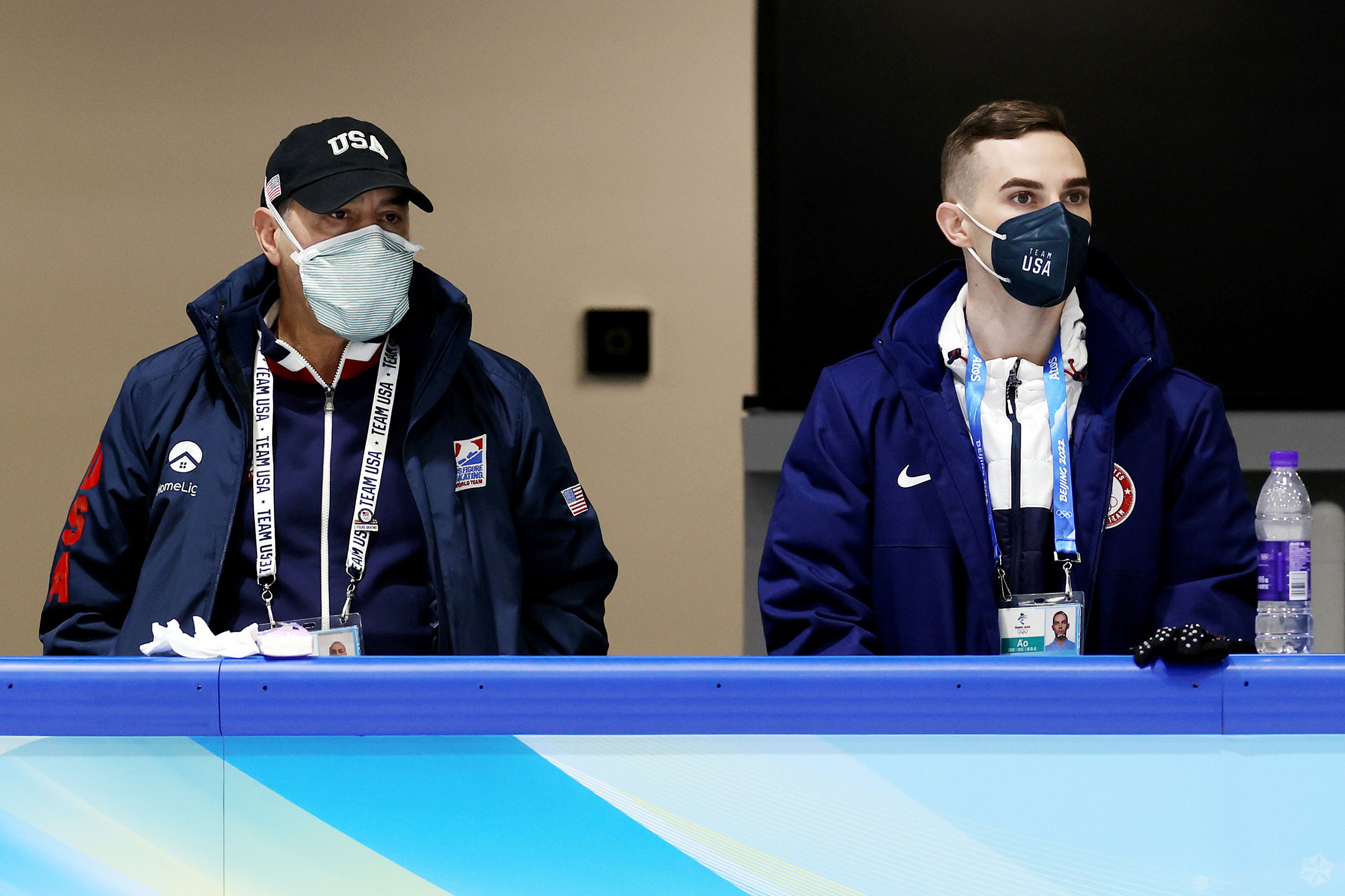 Coaches Rafael Arutyunyan (L) and Adam Rippon (R) look on during a practice session ahead of the Beijing 2022 Winter Olympic Games on Feb. 1.