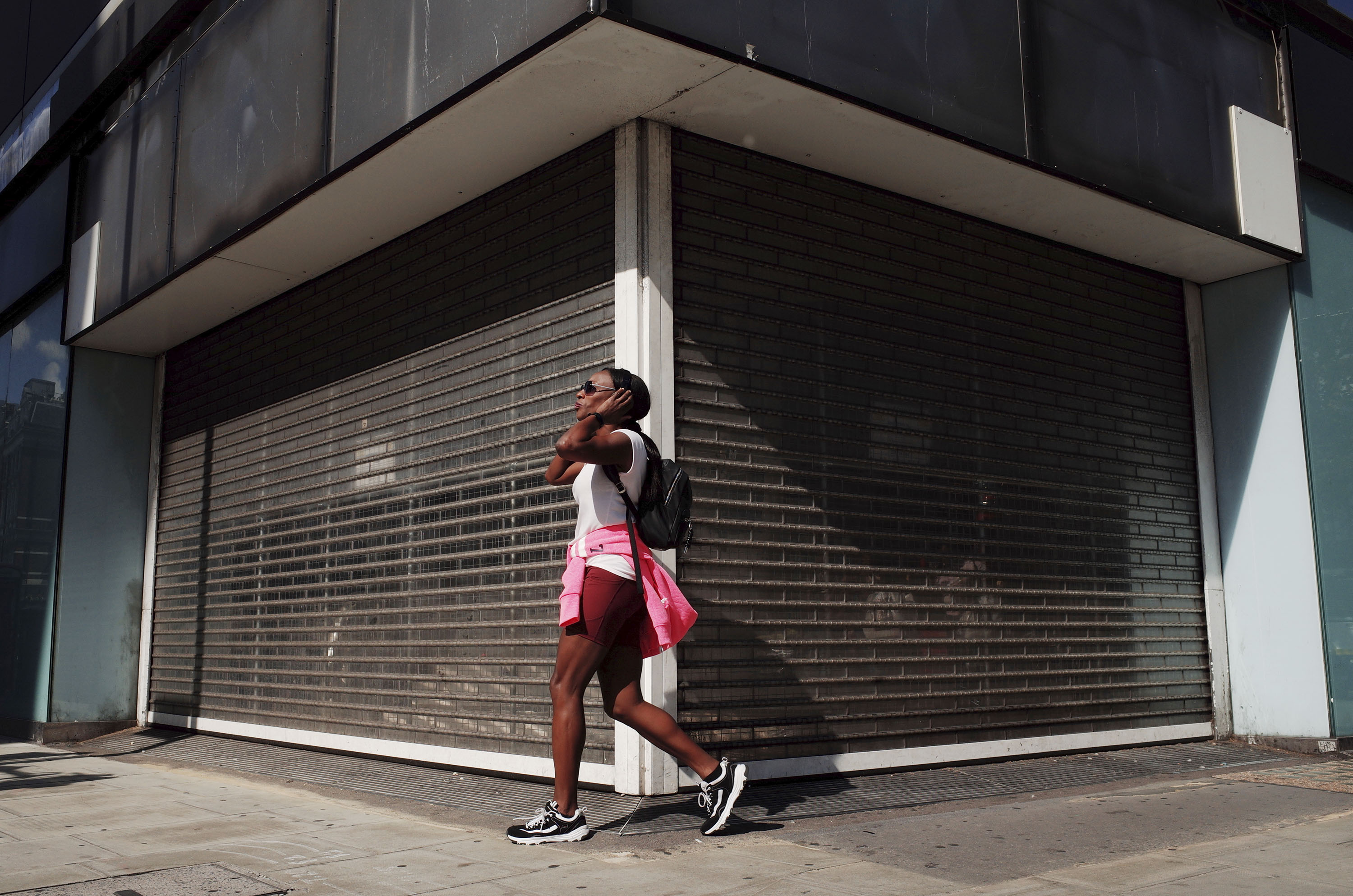 A woman walks past a vacant retail unit on Oxford Street in London, England, on July 22. 