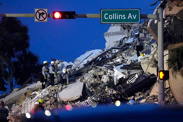 Rescue workers look through the rubble where a wing of a 12-story beachfront condo building collapsed.