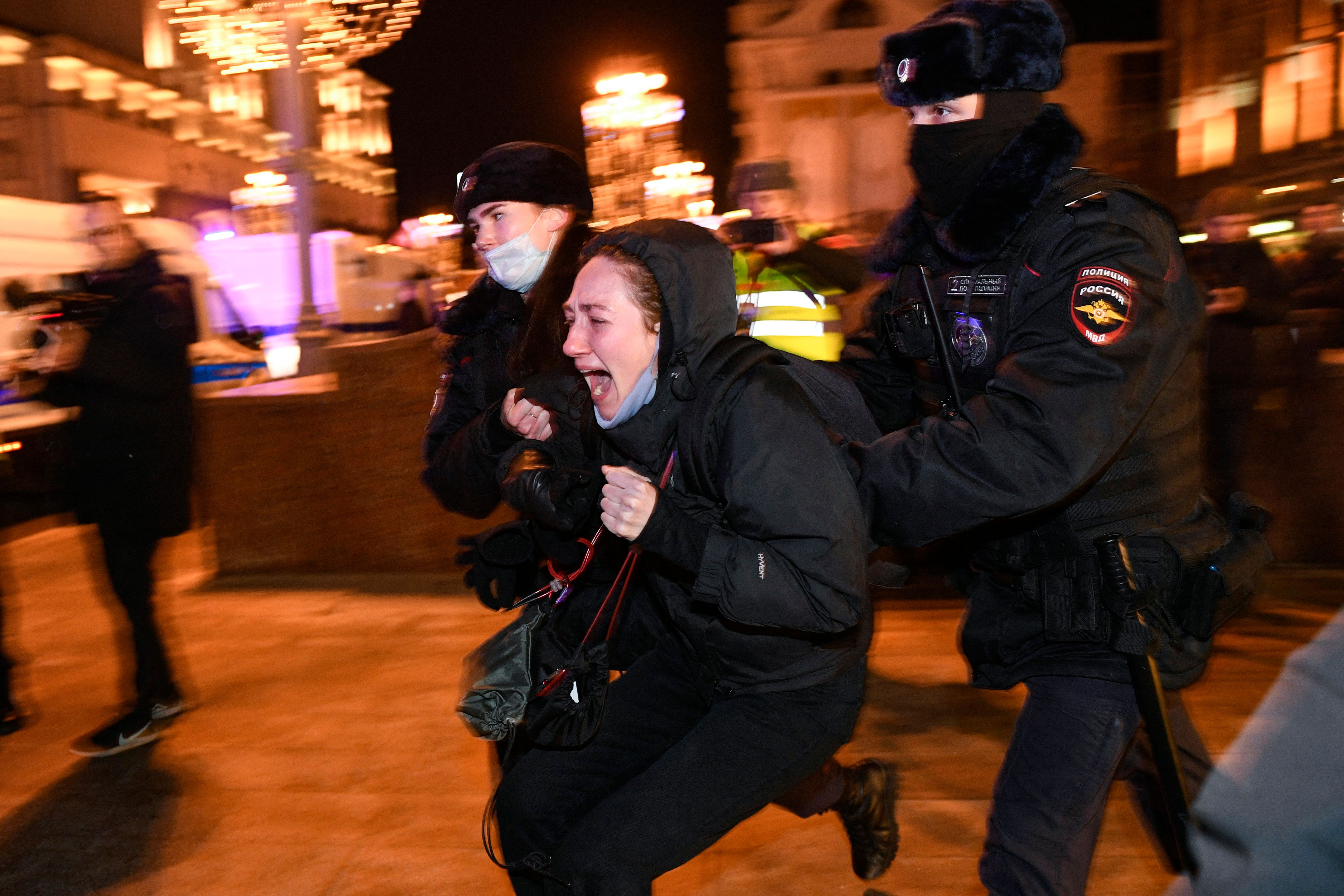 Police officers detain a demonstrator during a protest against Russia's invasion of Ukraine in Moscow on February 24.