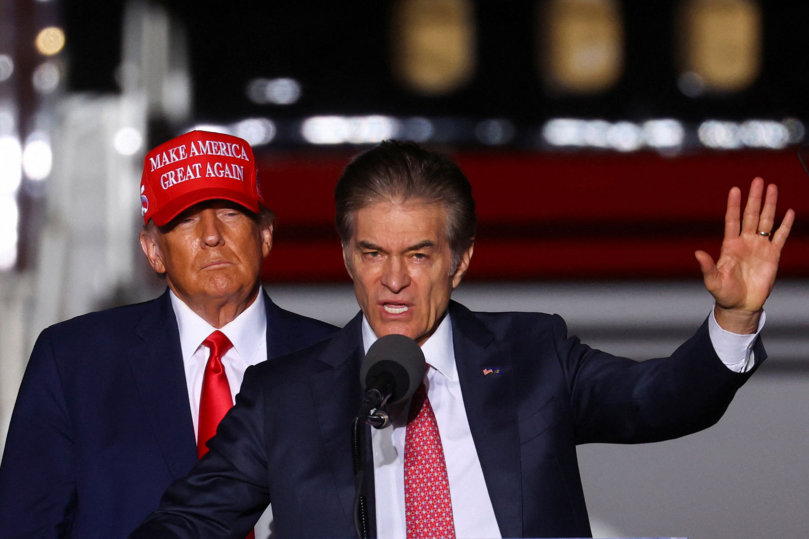 Mehmet Oz addresses a crowd of supporters with former President Donald Trump. 