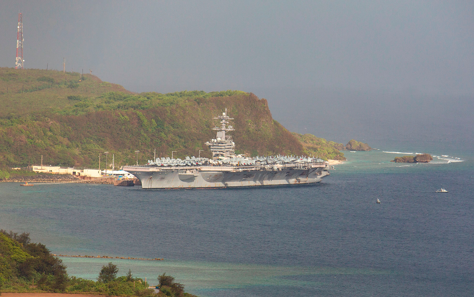 The aircraft carrier USS Theodore Roosevelt is docked at Naval Base Guam in Apra Harbor on Monday, April 27.