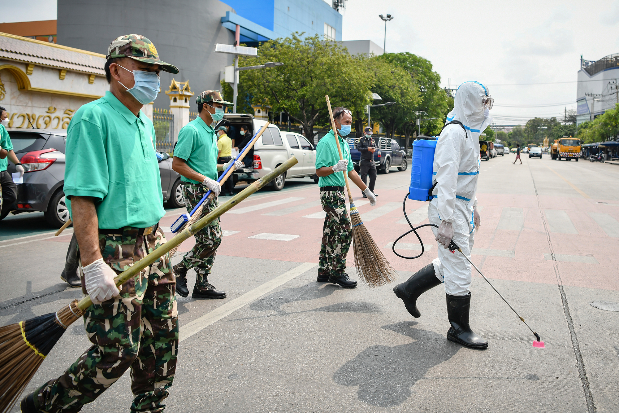 Volunteers wearing protective masks and gloves gather to clean the Chatuchak Weekend Market in Bangkok, Thailand, on Friday. 