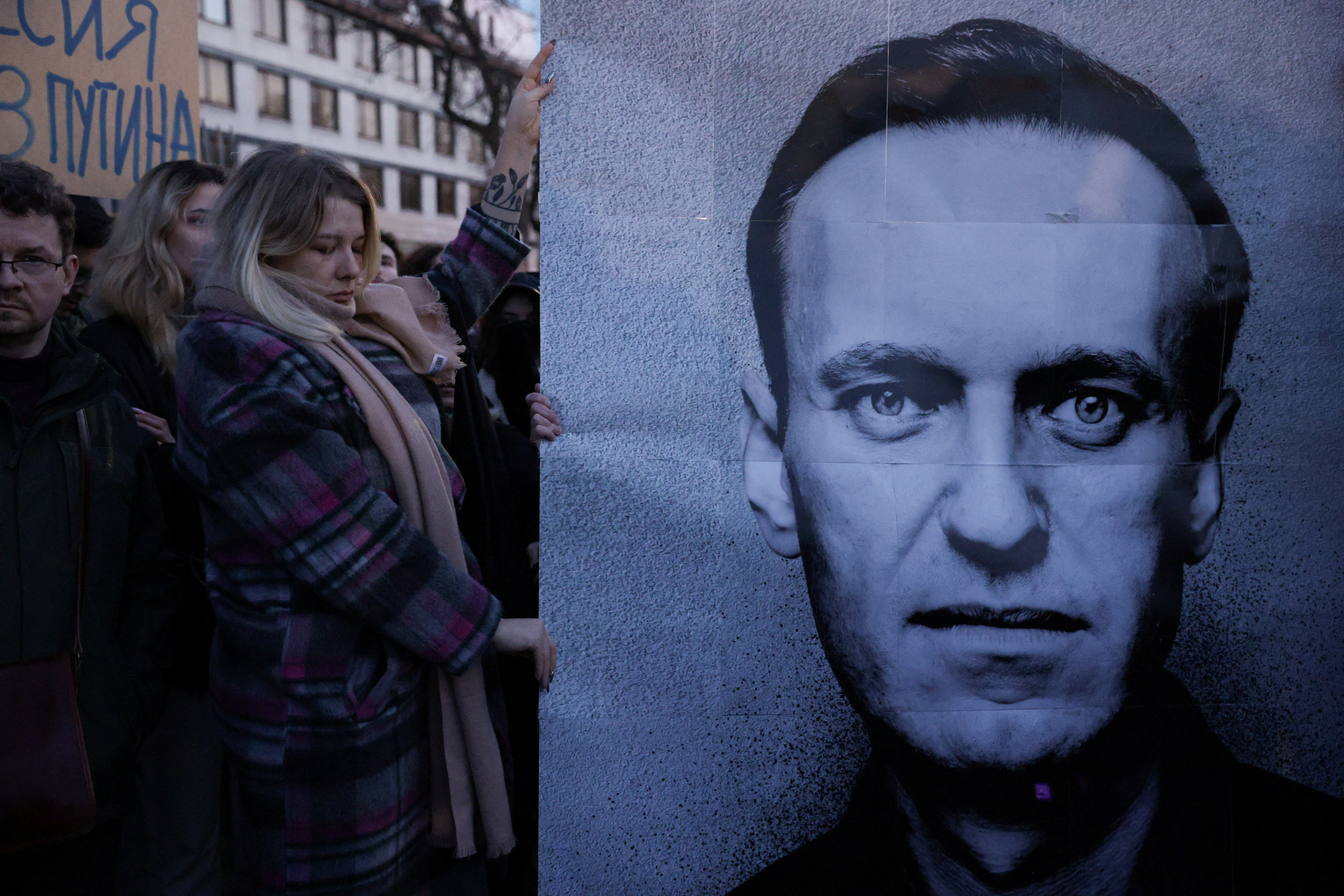 People gather outside the Russian embassy in Warsaw, Poland, following the death of Russian opposition figure Alexey Navalny, on February 16.