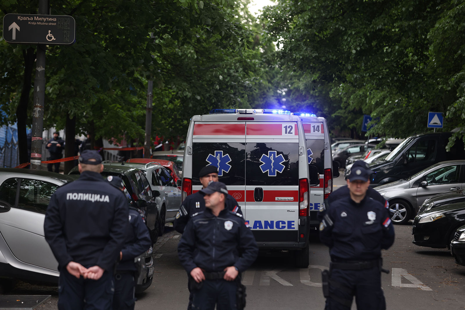 Ambulance cars arrive at the site as police officers block a street near the Vladislav Ribnikar elementary school in Belgrade, Serbia, on May 3. 