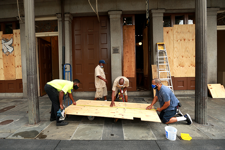 Workers board up windows in the French Quarter in anticipation of Hurricane Marco and Tropical storm Laura on August 23, 2020 in New Orleans, Louisiana. Both storms are expected to make landfall along the Louisiana coast within days of each other. 