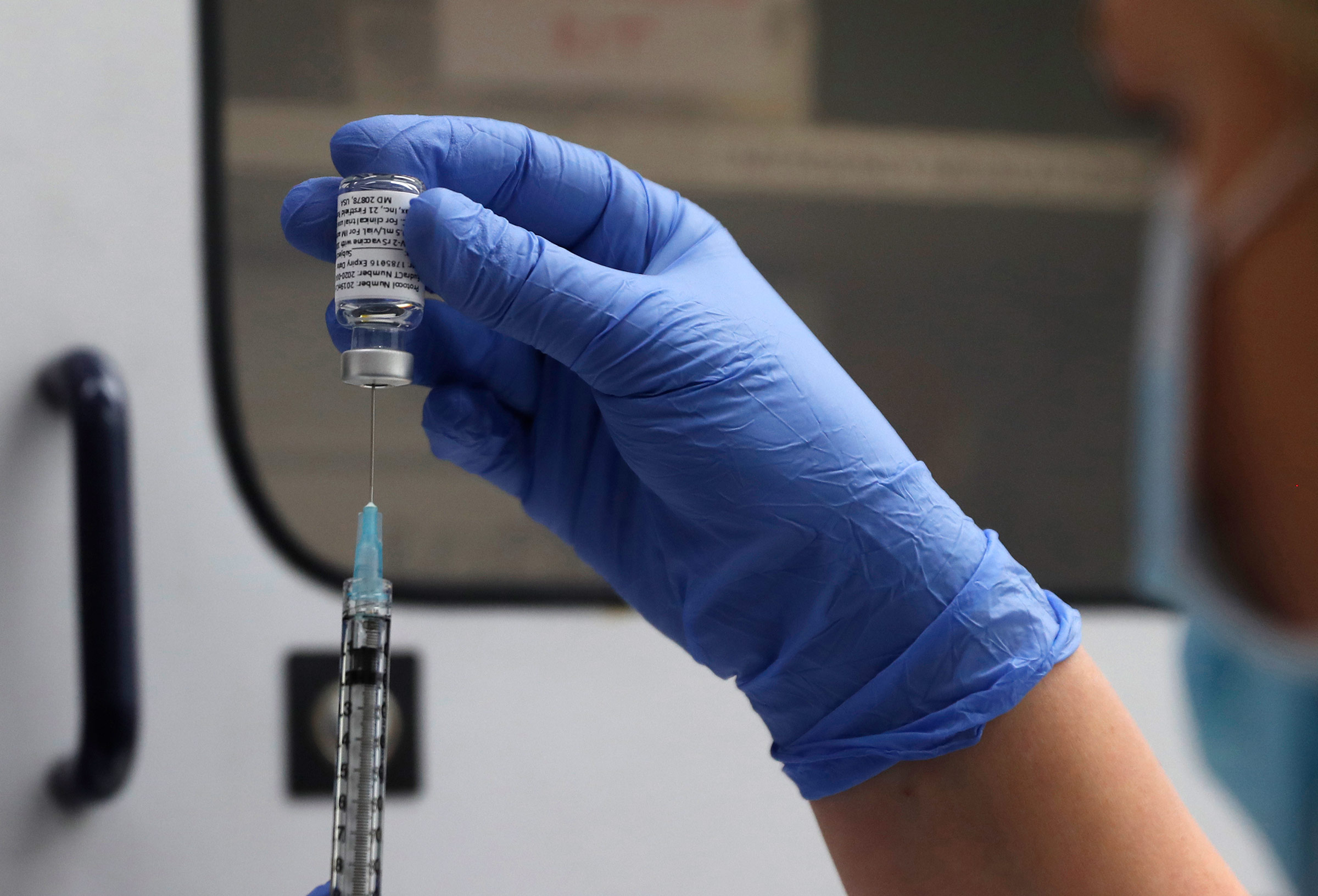 A syringe of the Novavax vaccine is prepared for use in the trial at St. George's University hospital in London on October 7, 2020. 