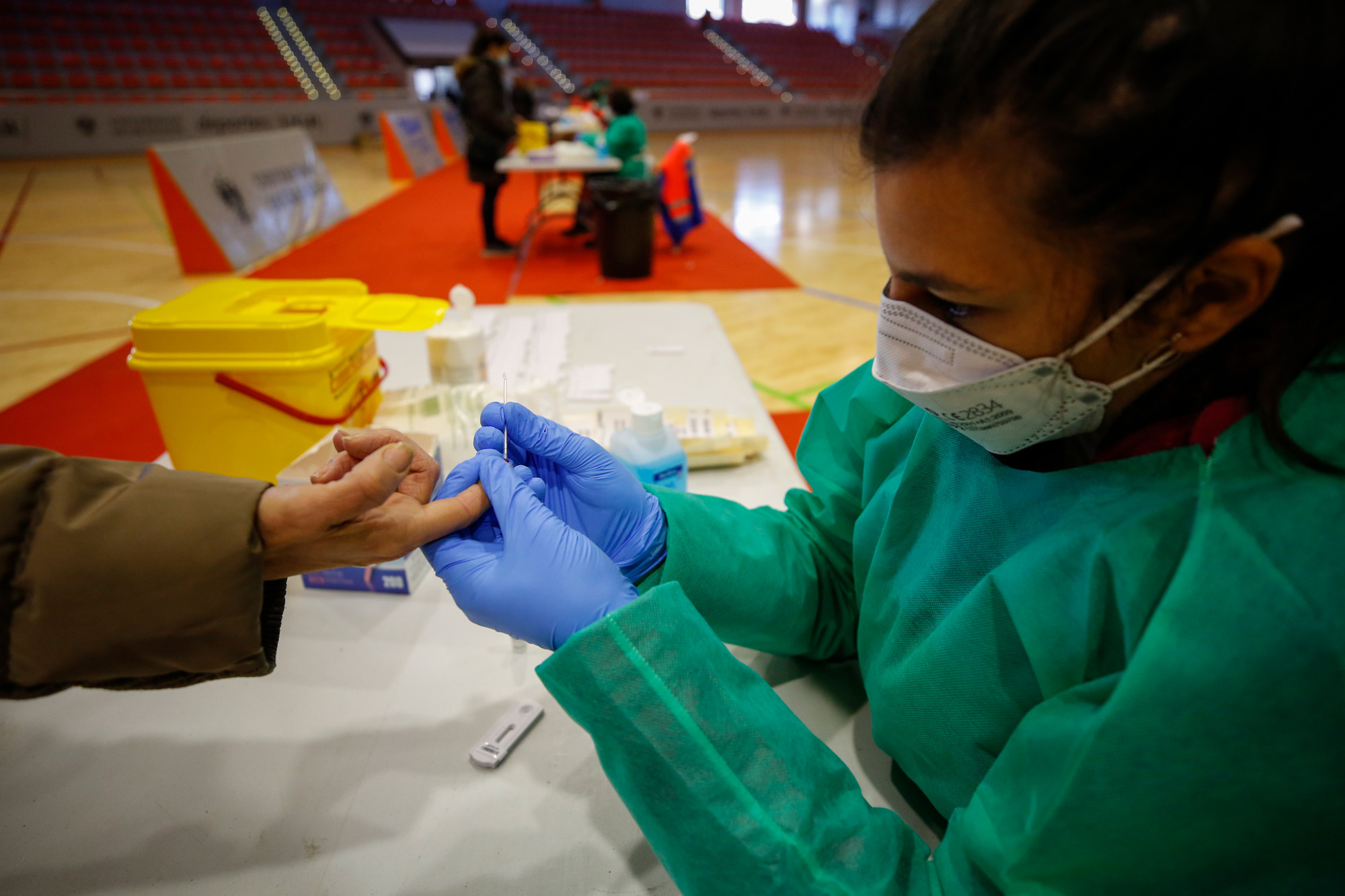 A health worker takes a blood sample during a massive coronavirus antigen testing on January 4 in Granada, Spain. 