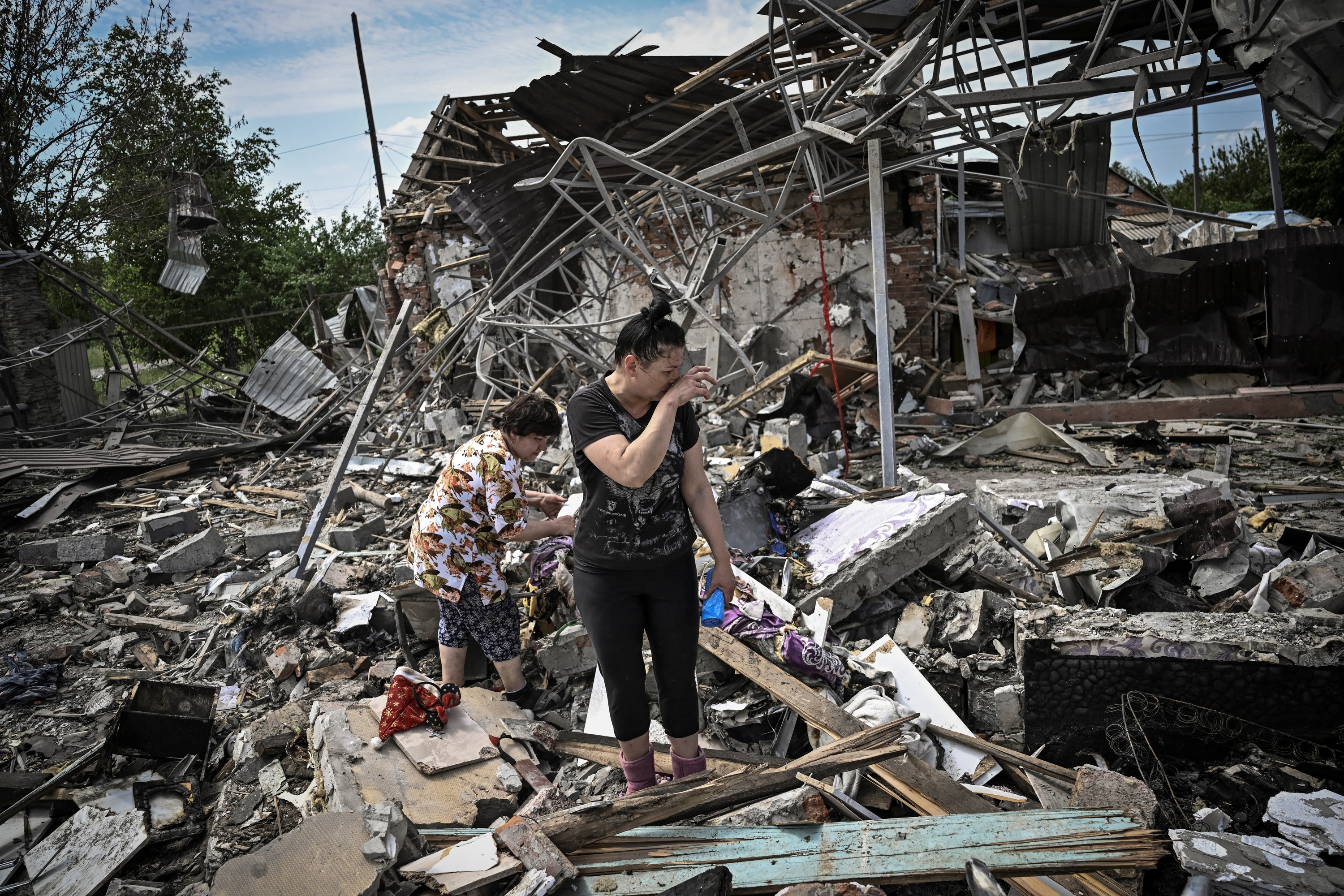 Residents look for belongings after a strike destroyed homes in Sloviansk, Ukraine on June 1. 
