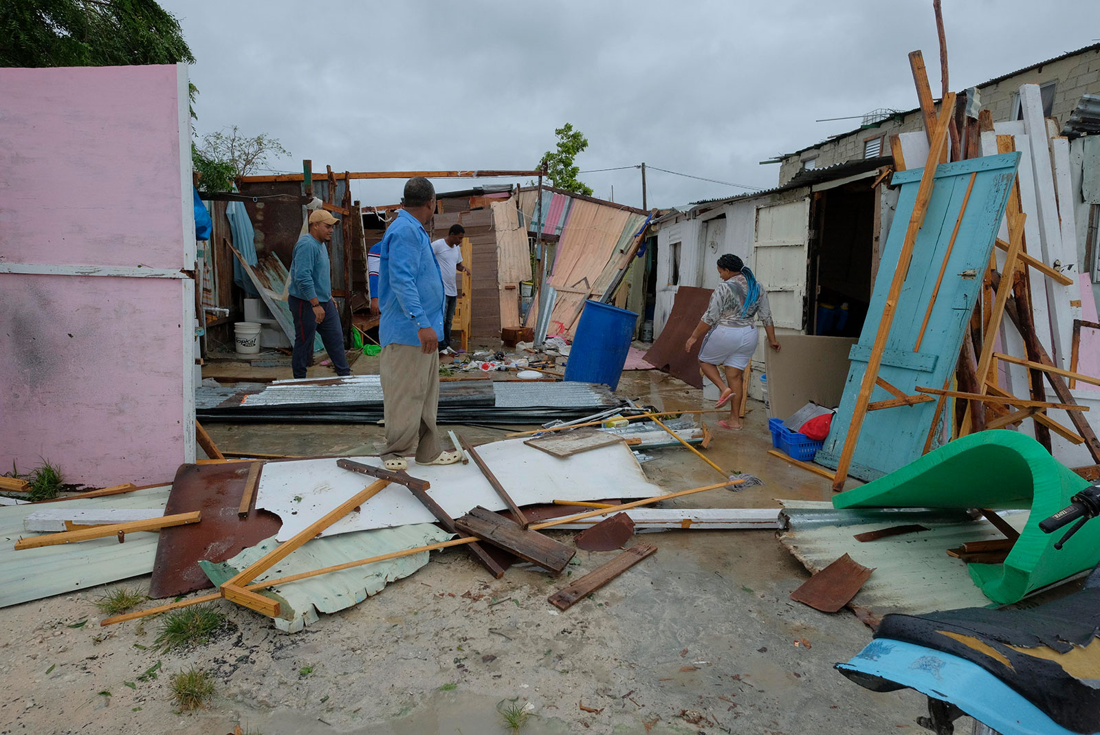 Residents stand amid their homes that were damaged by Hurricane Fiona in the neighborhood of Kosovo in Veron de Punta Cana, Dominican Republic on September 19. 