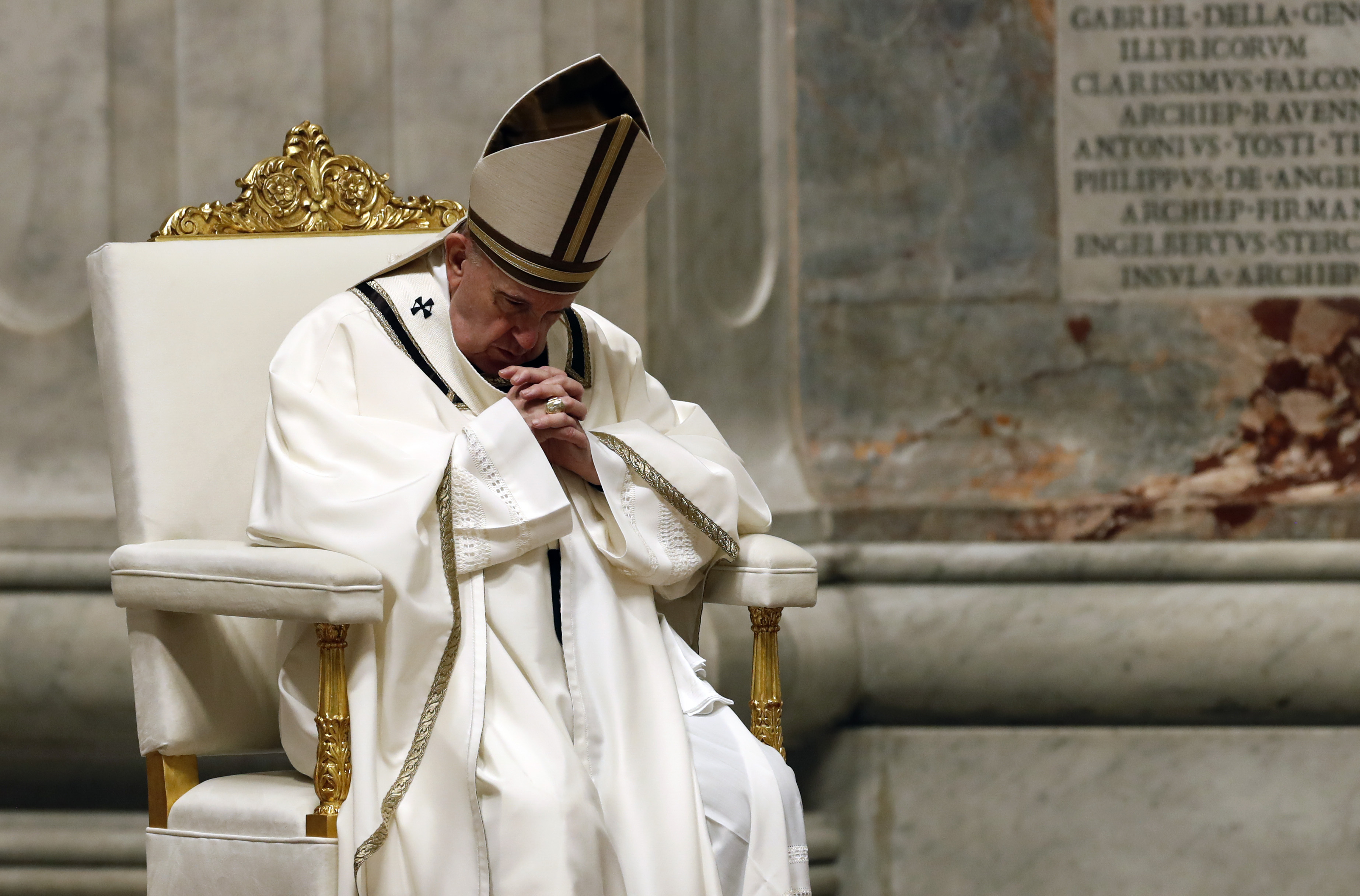 Pope Francis presides over an Easter vigil in St. Peter's Basilica in the Vatican on April 11.