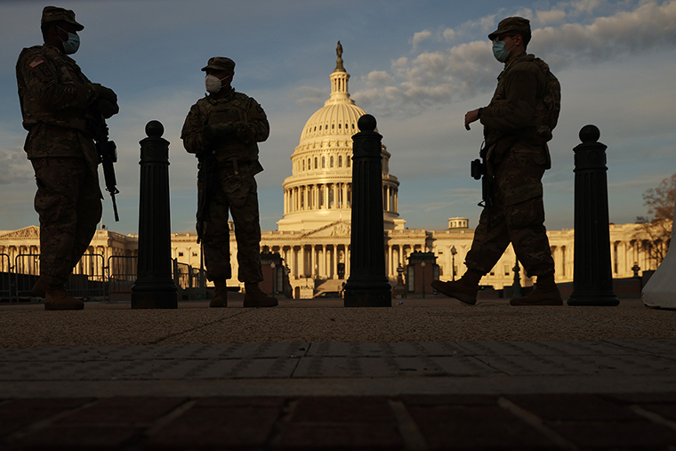 Members of the New York National Guard stand guard along the fence that surrounds the U.S. Capitol on January 14, 2021 in Washington, DC.