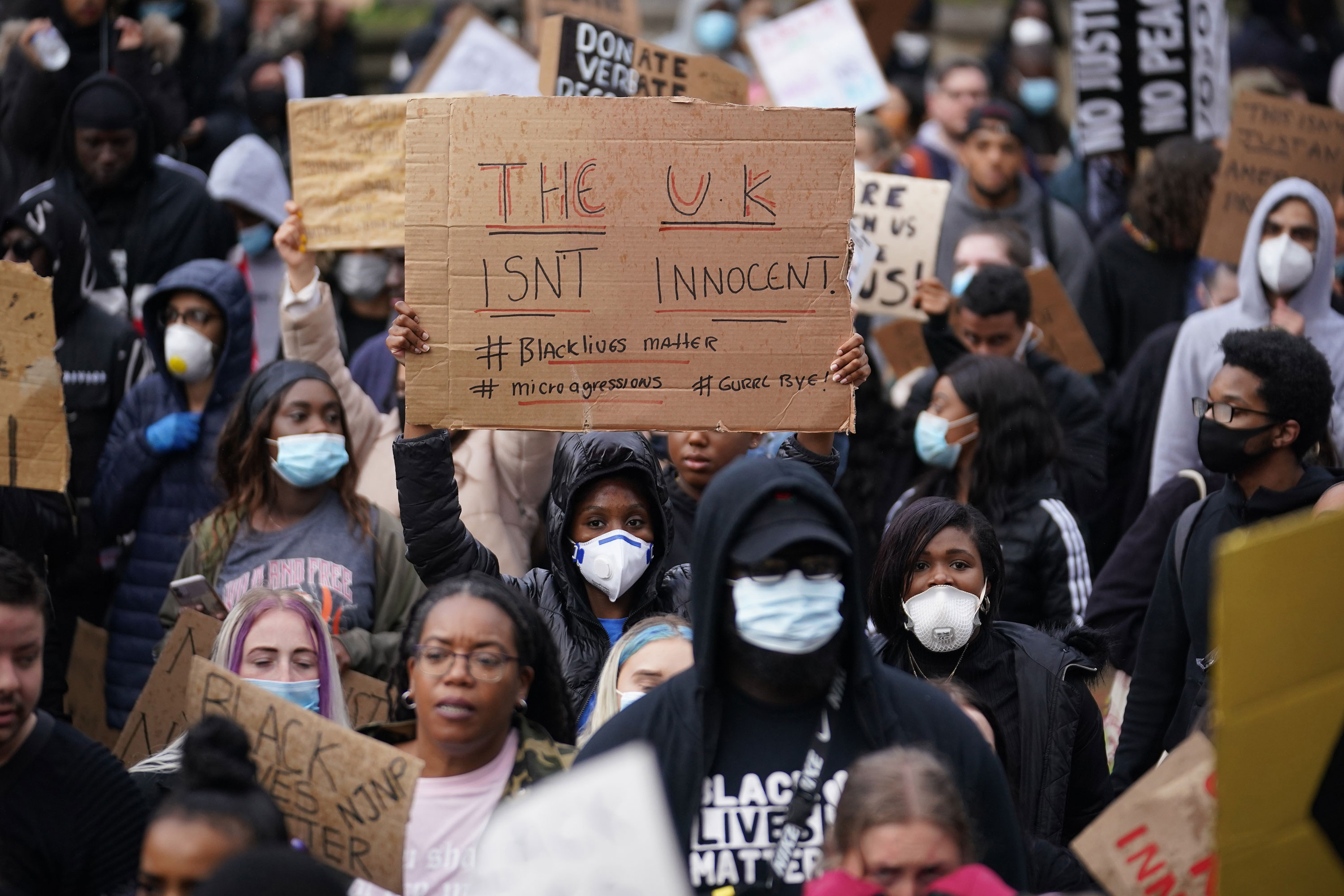 Protesters hold signs during a Black Lives Matter demonstration on June 4 in Birmingham, United Kingdom. 