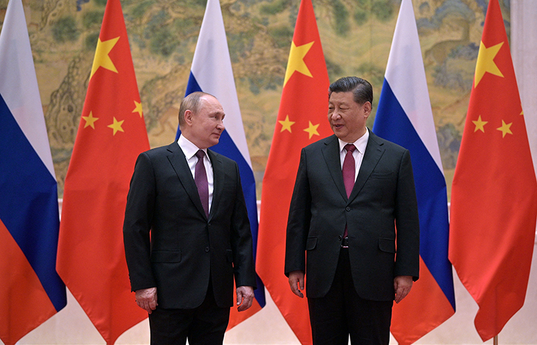 Russian President Vladimir Putin, left, and Chinese President Xi Jinping pose during their meeting in Beijing, on February 4.