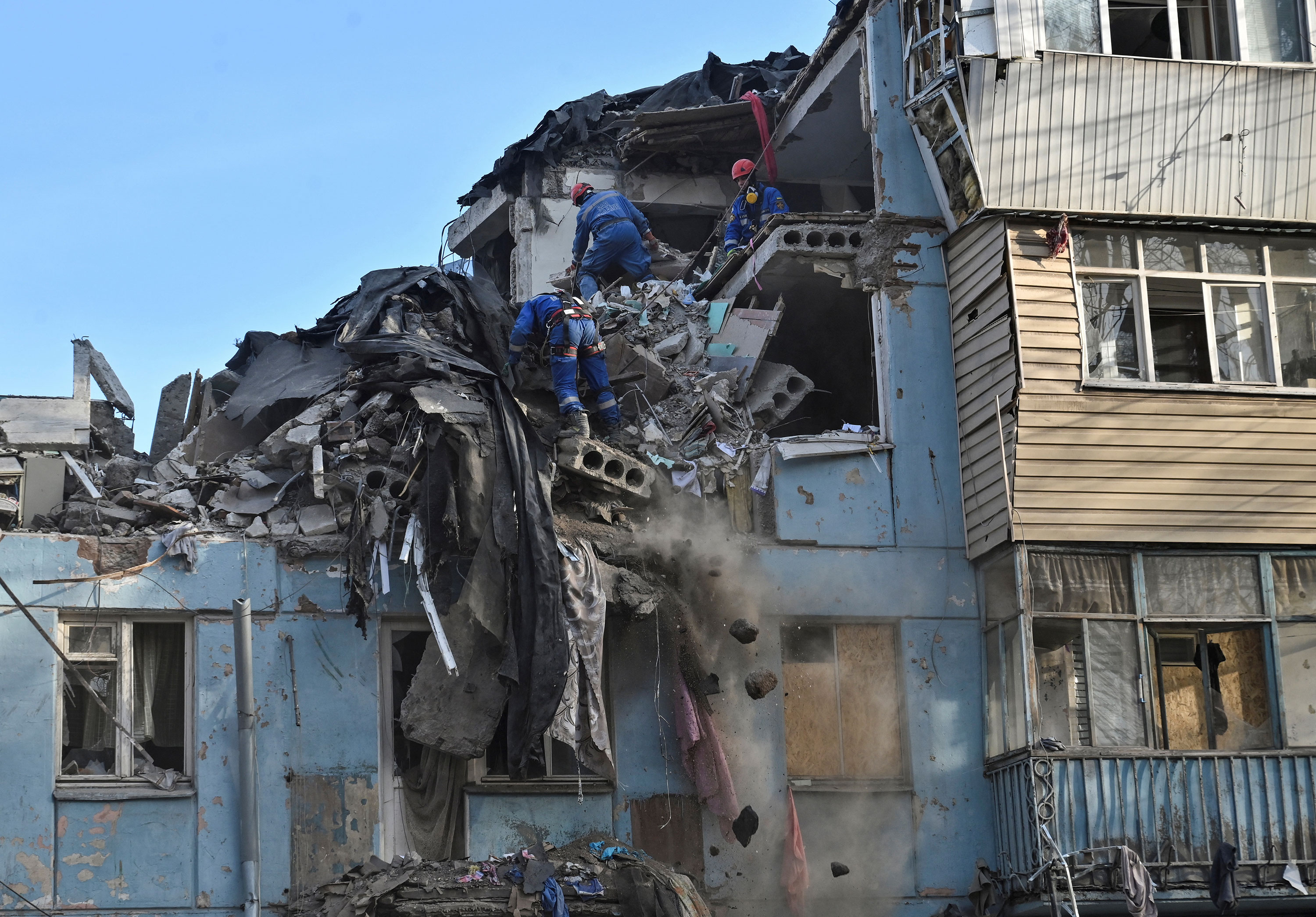 Rescuers work at a site of a residential building heavily damaged by a Russian missile strike in Zaporizhzhia on March 4. 