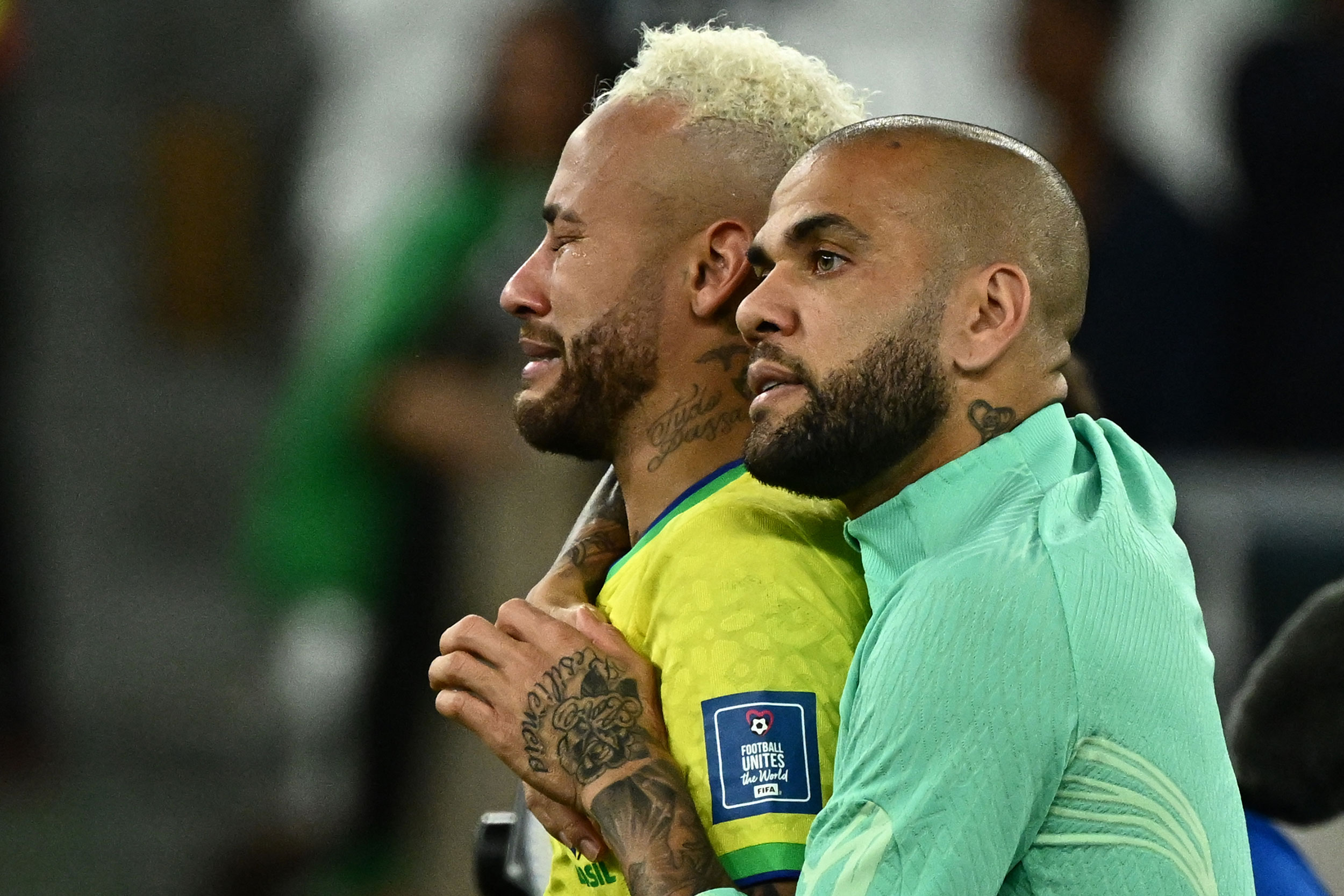 Brazil’s Neymar, left, is comforted by teammate Dani Alves after being eliminated from the World Cup.