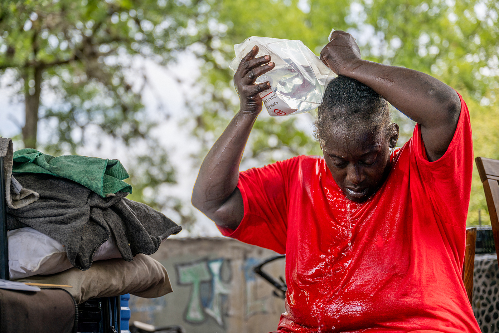 A woman pours water on herself to cool off in Austin, Texas on July 11.