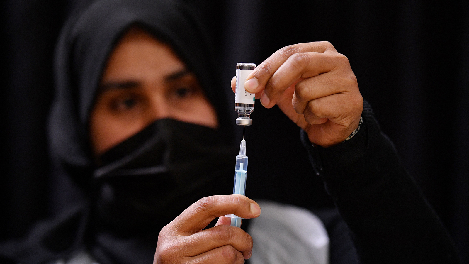 A health worker prepares an injection of the AstraZeneca Covid-19 vaccine at a temporary vaccination cener set up at the East London Mosque in London on April 14.