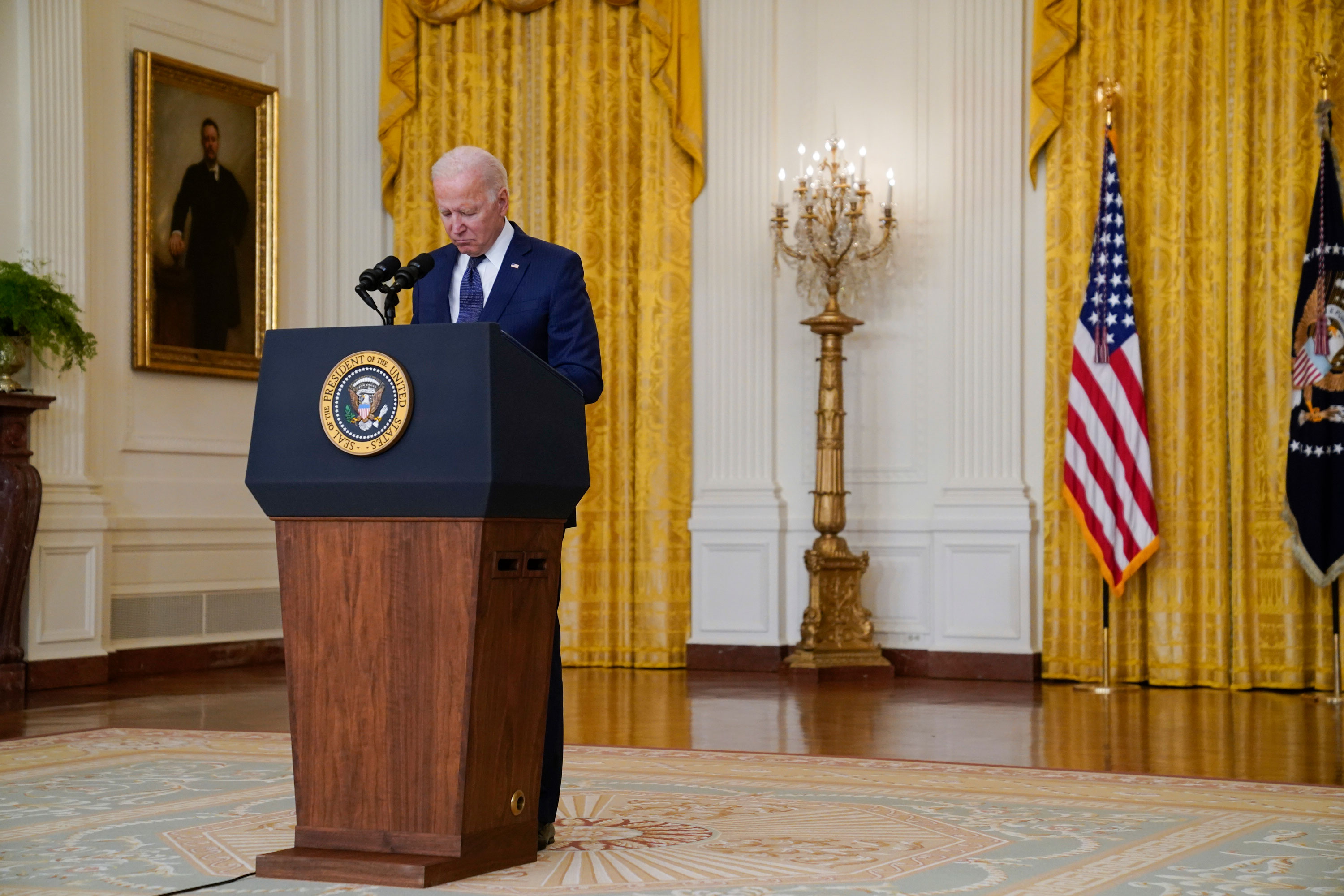 President Joe Biden pauses for a moment of silence from the East Room of the White House on August 26 in Washington, DC.