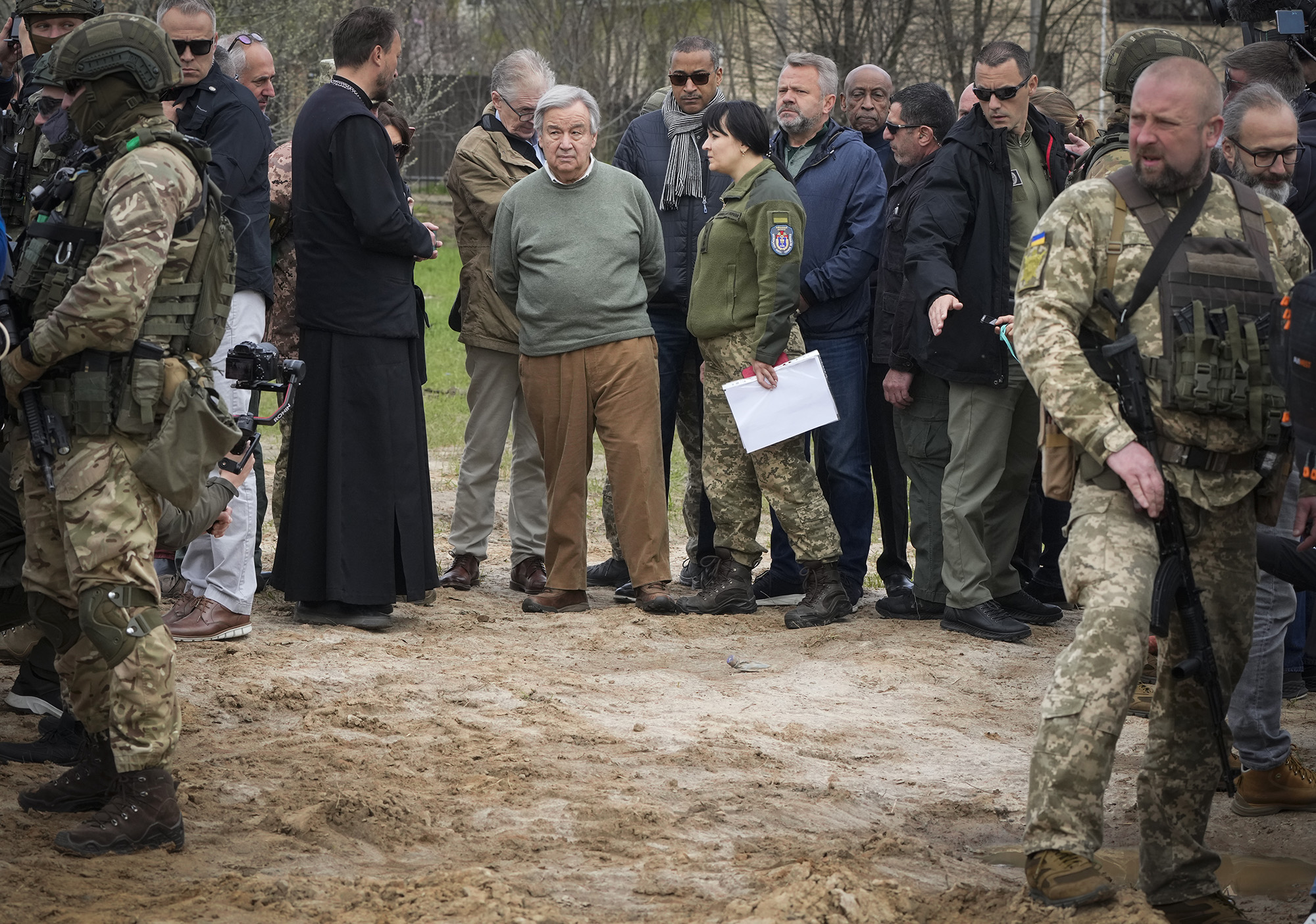 U.N. Secretary-General Antonio Guterres stands near the side of a mass grave in Bucha, on the outskirts of Kyiv, Ukraine on Thursday April 28.