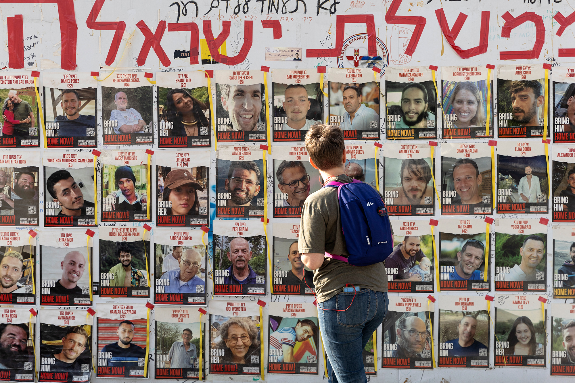 A women looks at photos of hostages held by Hamas in Gaza, on May 1, in Tel Aviv, Israel. 