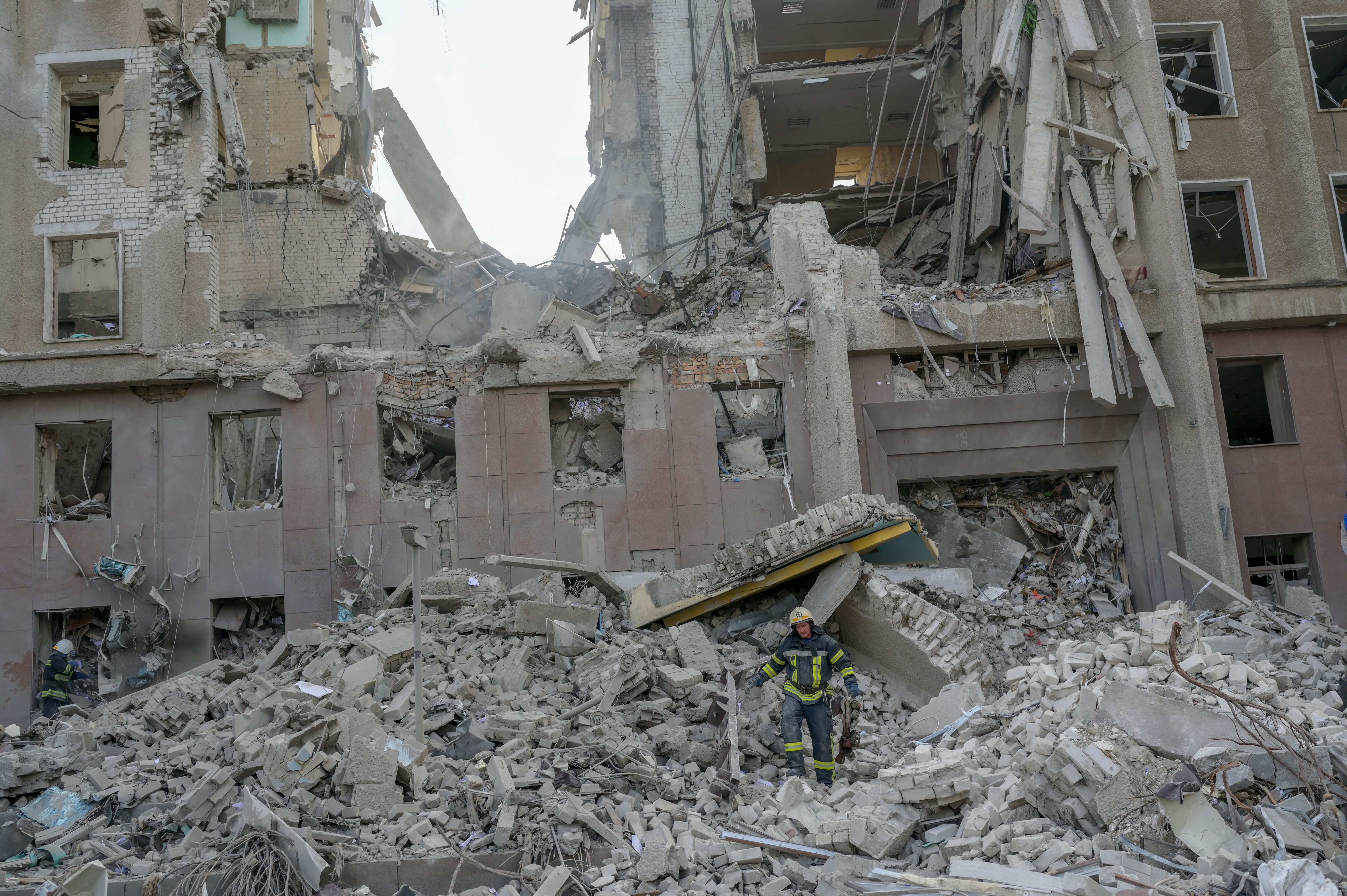 A firefighter clears the rubble of a government building hit by Russian rockets in Mykolaiv, Ukraine, on March 29, 