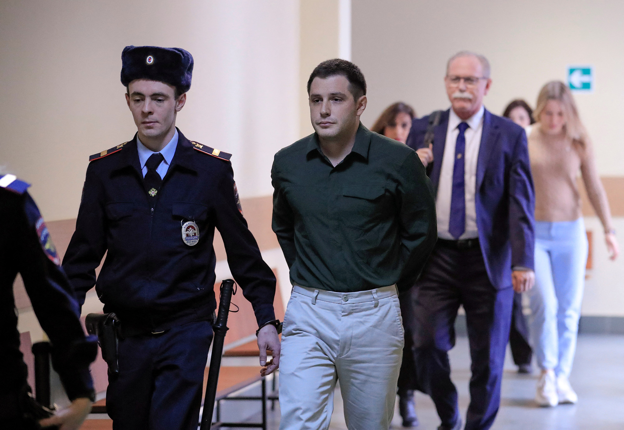 U.S. ex-Marine Trevor Reed, who was detained in 2019 and accused of assaulting police officers, is escorted before a court hearing in Moscow, Russia, on March 11, 2020.