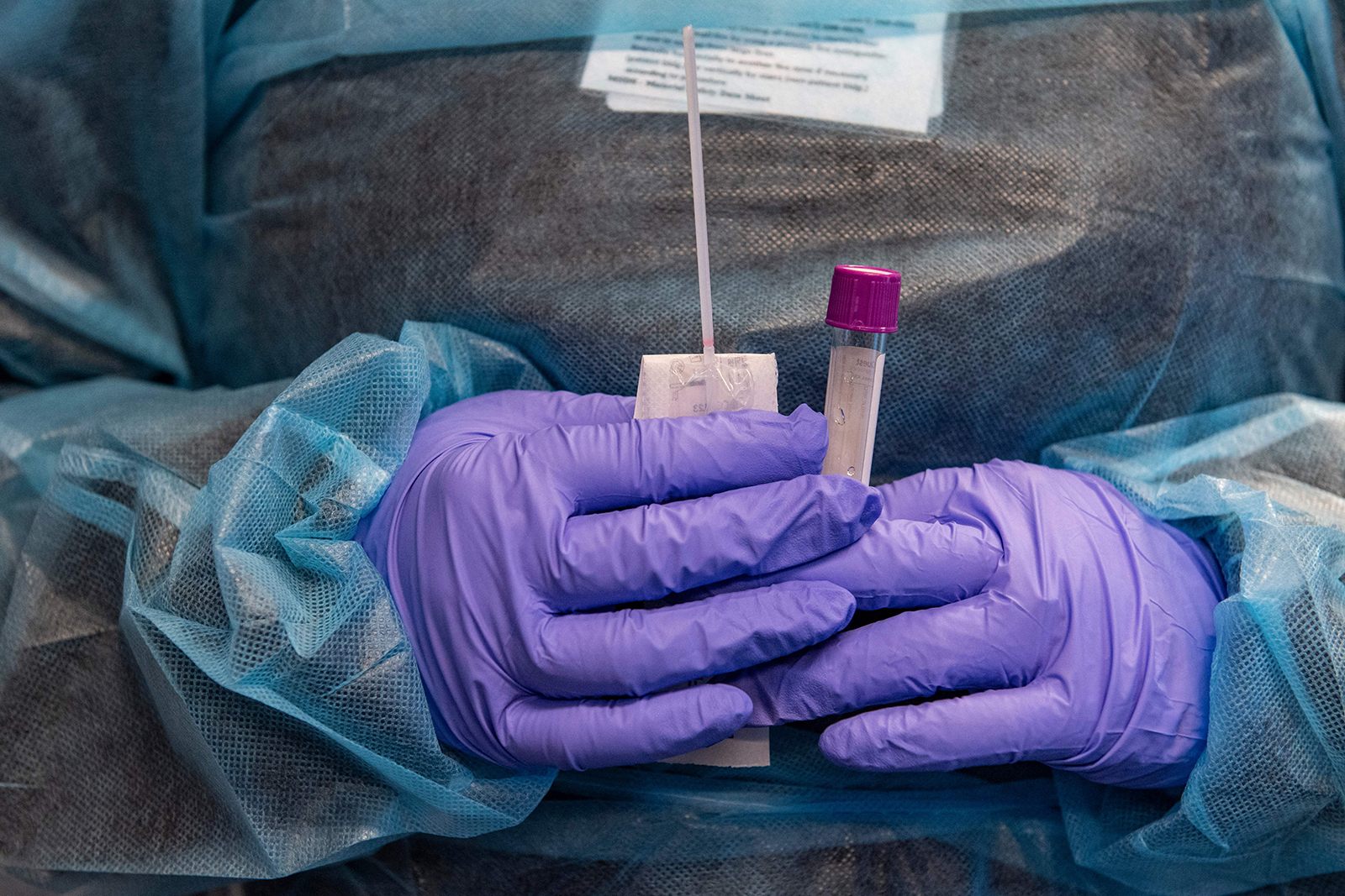 A medical worker prepares a Covid-19 PCR test at East Boston Neighborhood Health Center in Boston, Massachusetts on December 20.