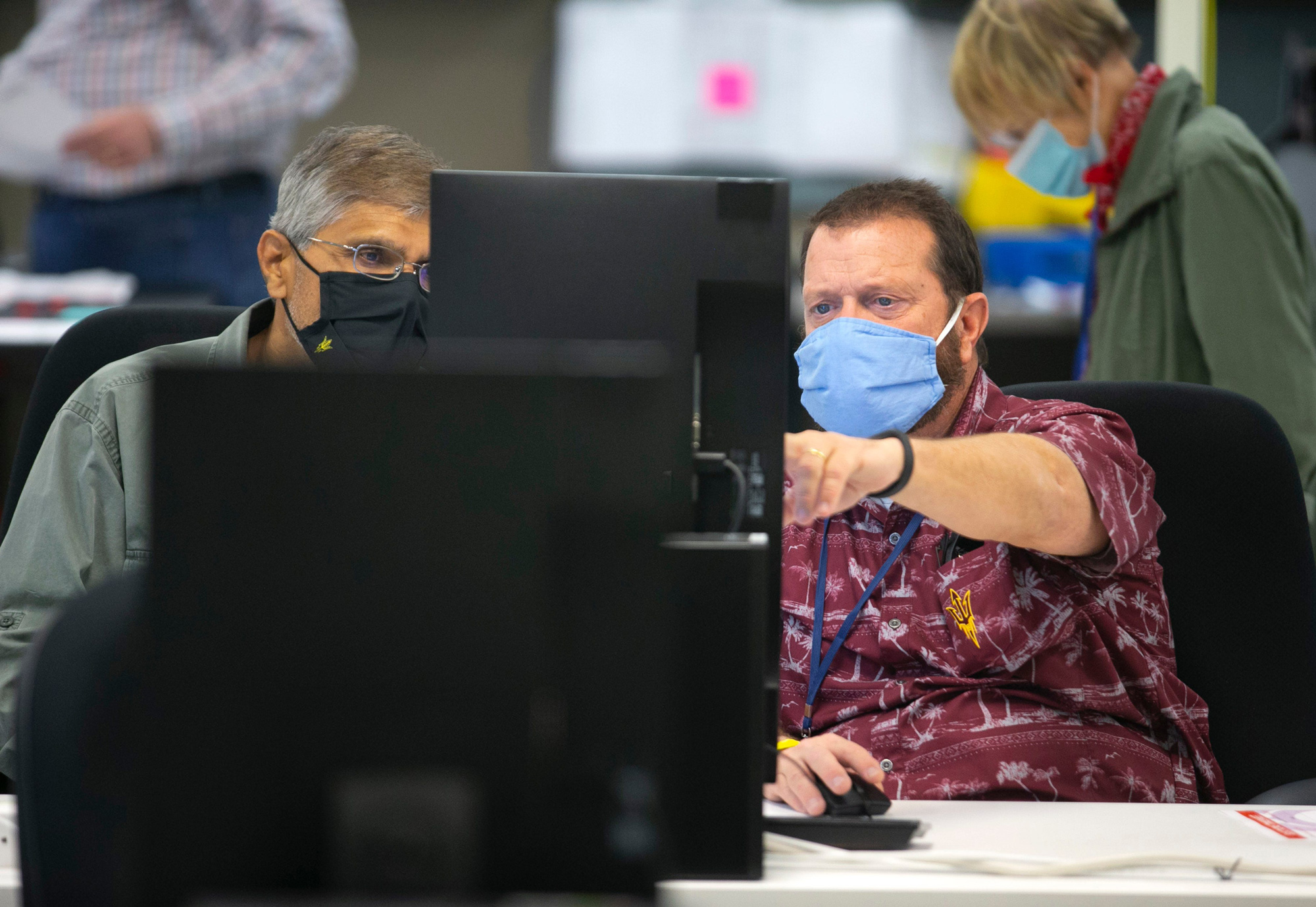 Maricopa County Elections adjudicators check ballots at the Maricopa County Elections headquarters in Phoenix on November 9.