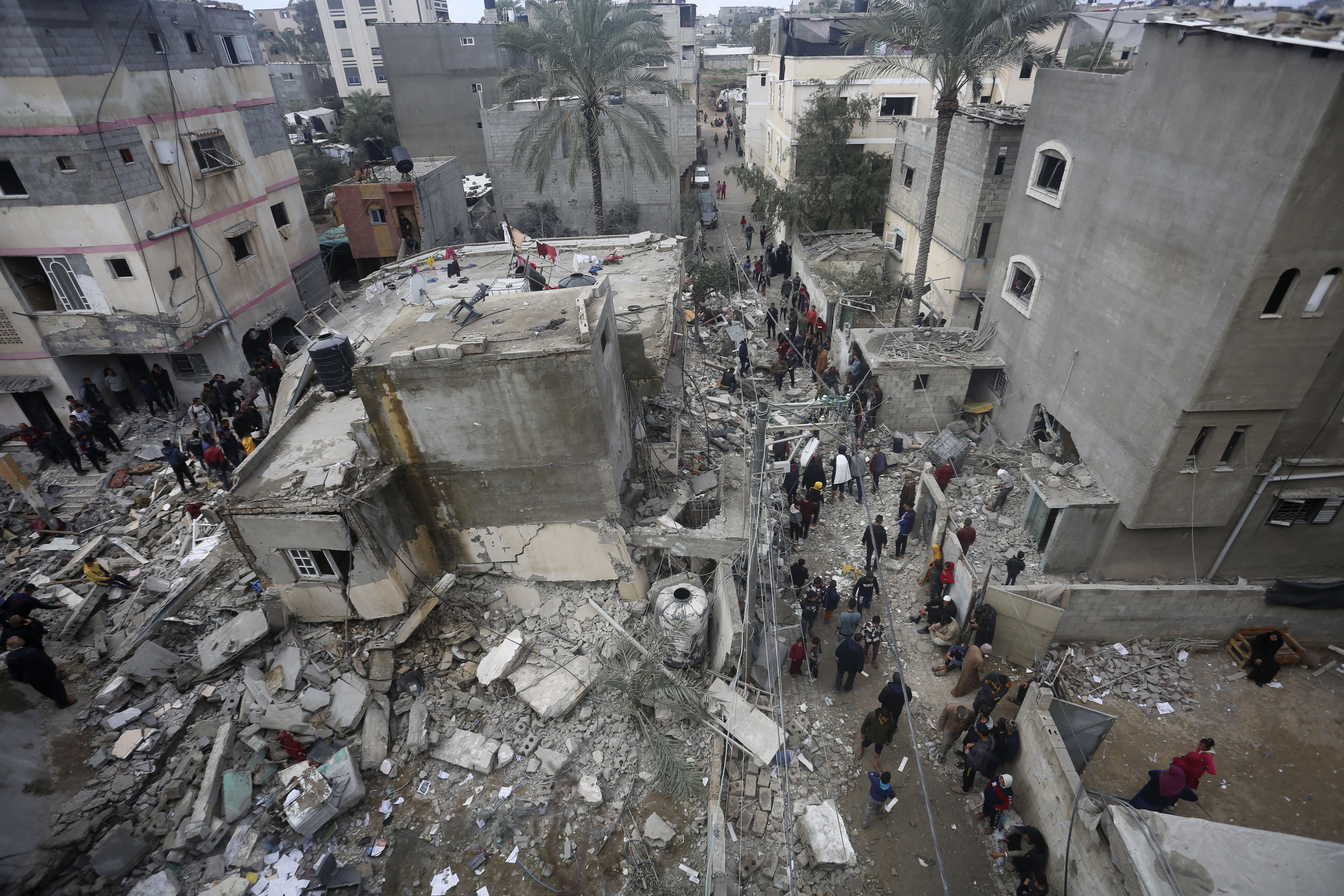 People search for victims in the rubble of the Baraka family home in Deir al-Balah, Gaza, after an Israeli airstrike on February 18.
