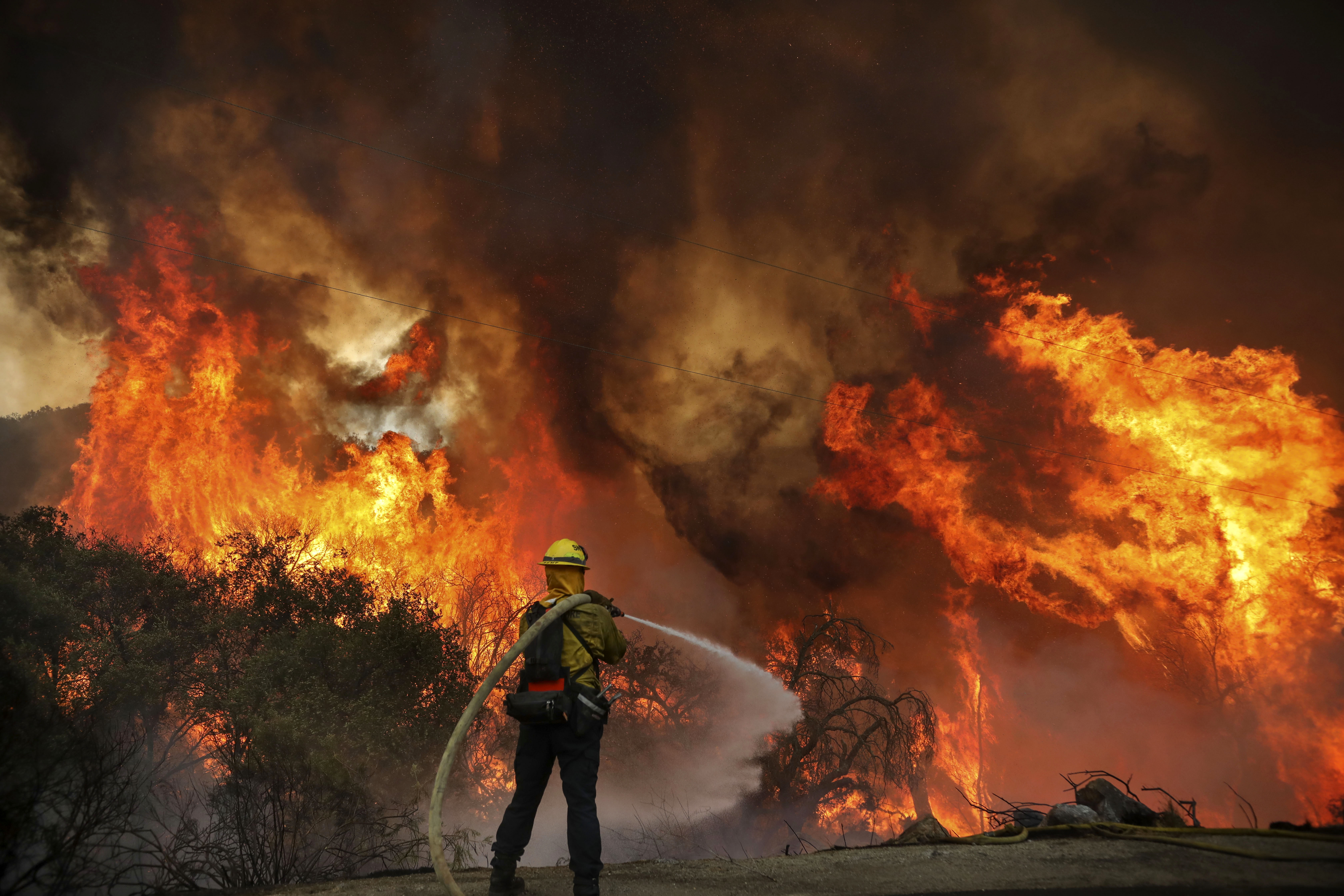 A firefighter in Jamul, California, battles the Valley Fire along Japatul Road on September 6.