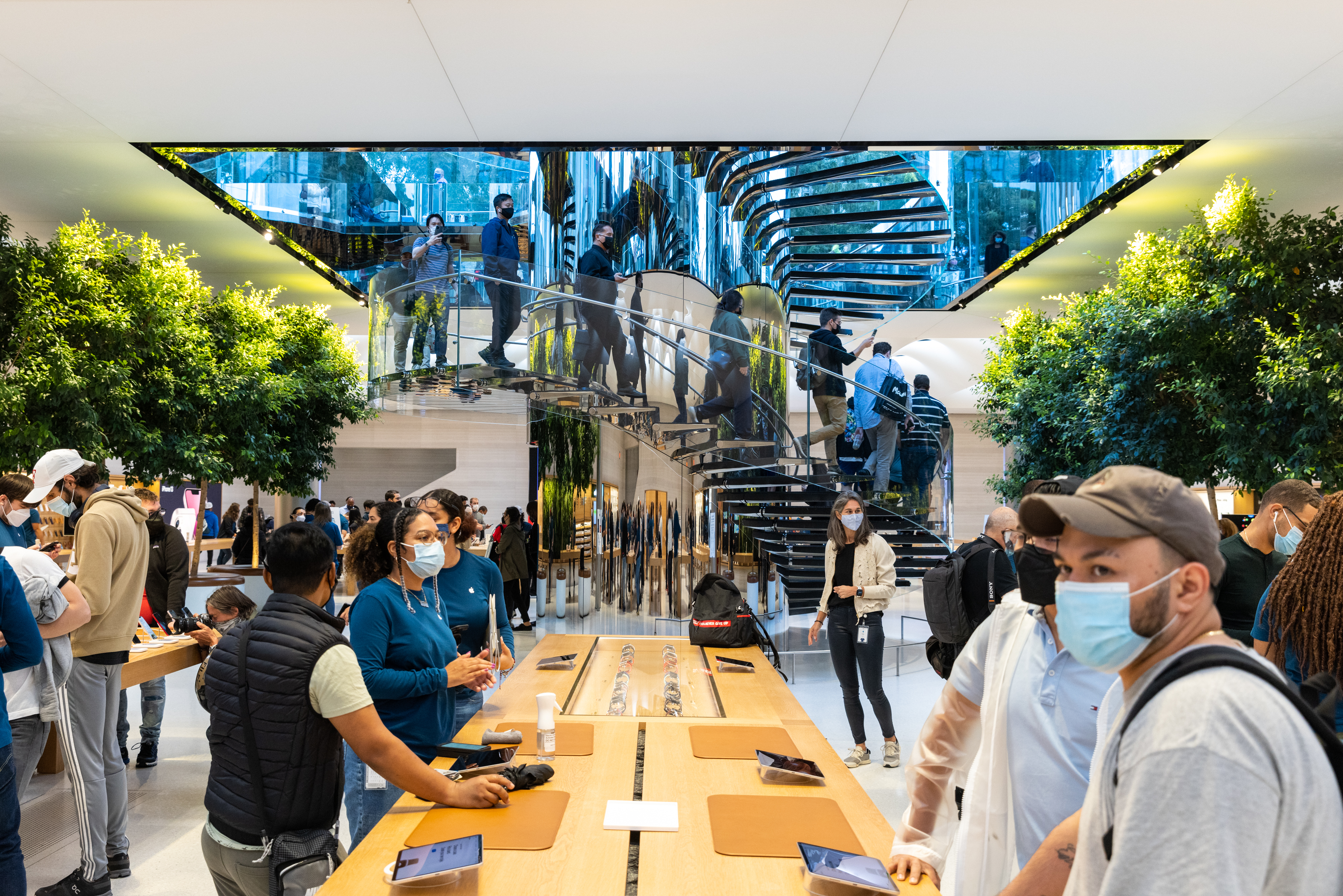 Customers inside an Apple store in New York, U.S., on Friday, Sept. 24, 2021.