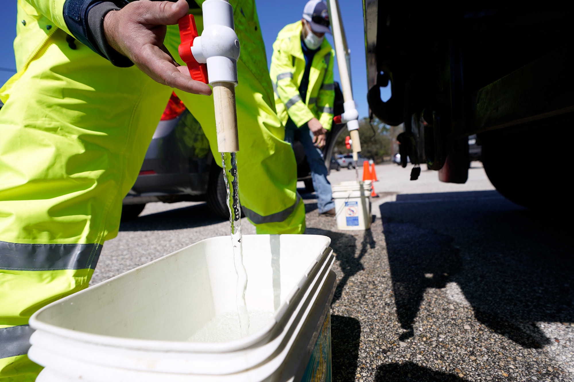 Containers are filled with non-potable water at a water distribution site on February 19 in Houston, Texas.