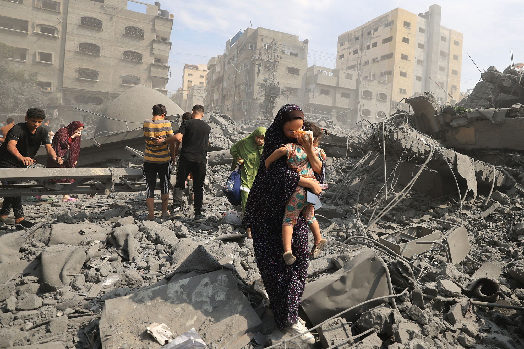 Palestinians evacuate the area following an Israeli airstrike on the Sousi mosque in Gaza on October 9.