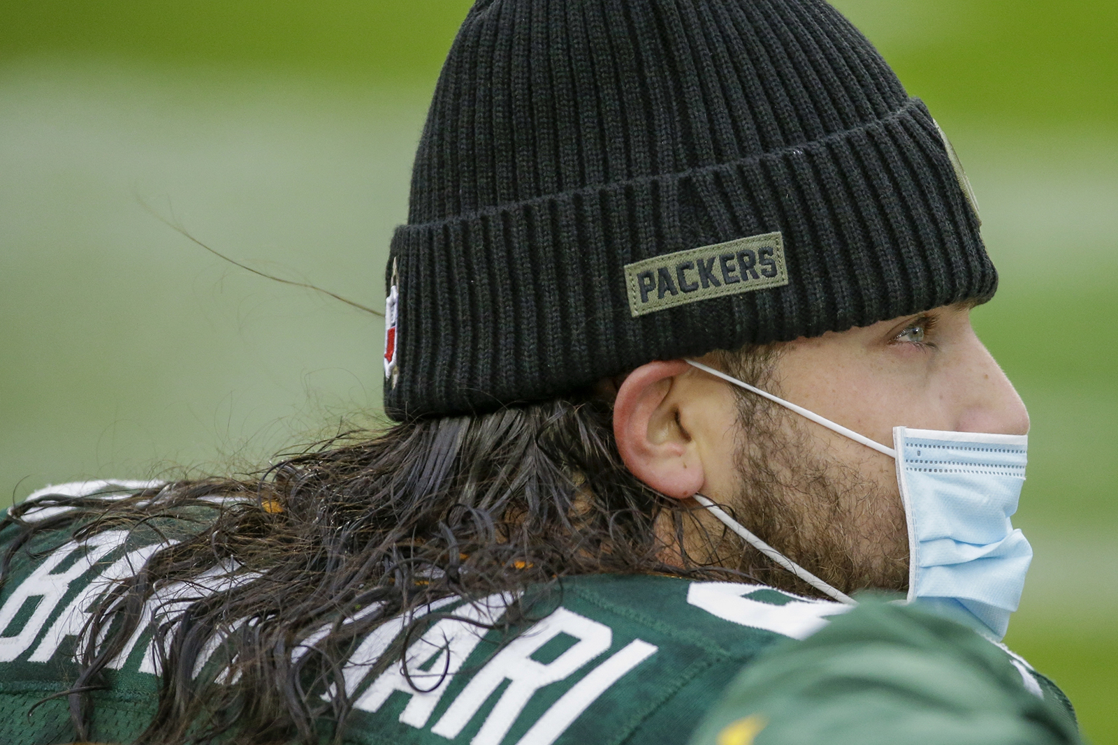 Green Bay Packers' David Bakhtiari wears a face mask on the bench during the first half of an NFL football game against the Jacksonville Jaguars on Sunday, Nov. 15, in Green Bay, Wisconsin.