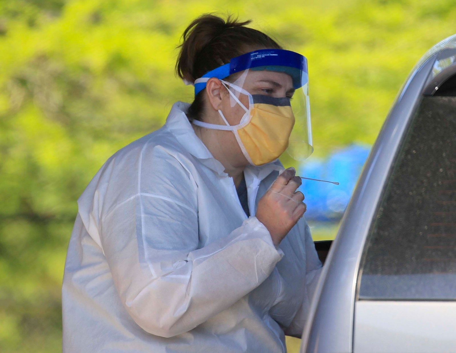 Nurse Tonya Green administers a coronvirus test at a drive-thru testing center in North Little Rock, Arkansas, on April 20.