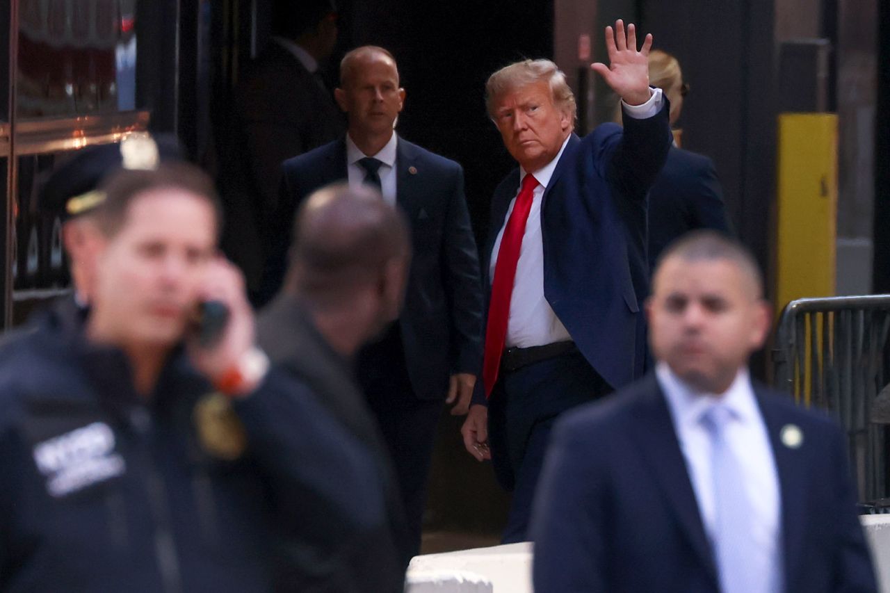 Former President Donald Trump waves to supporters upon arriving at Trump Tower in New York on Monday, April 3. Trump is in New York for an expected arraignment on Tuesday.