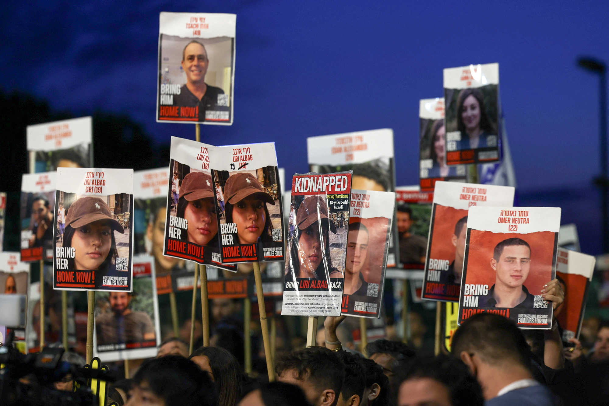 People carry pictures of the hostages during a rally for their immediate release near the Knesset, Israel's parliament in Jerusalem, on April 7.