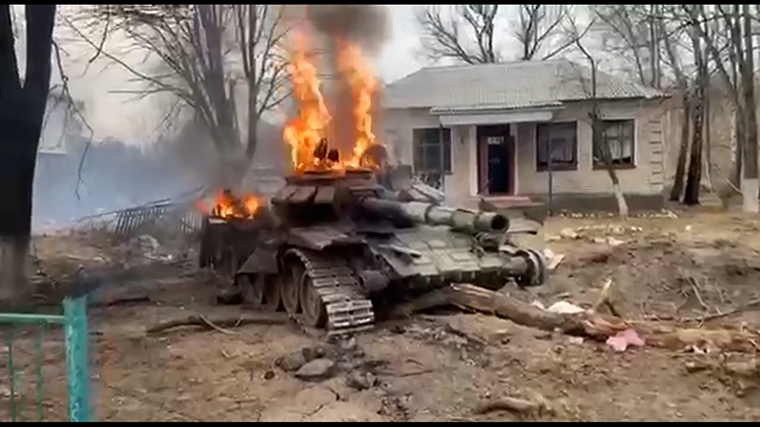 A bombed-out, enflamed Russian tank