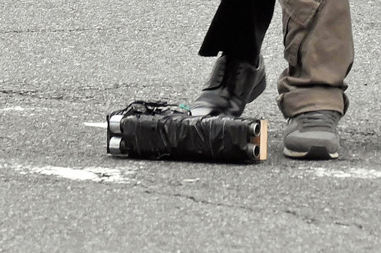 A cropped version of the above photo shows the weapon on the ground. 