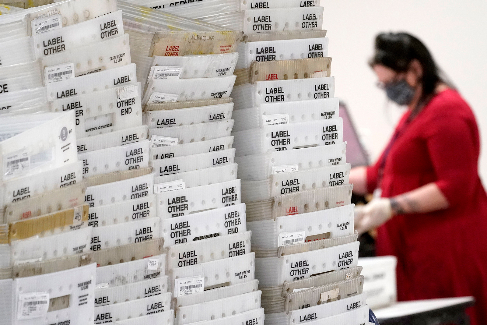 Stacks of ballots are seen inside the Maricopa County Recorder's Office, Friday, Nov. 6, in Phoenix. 