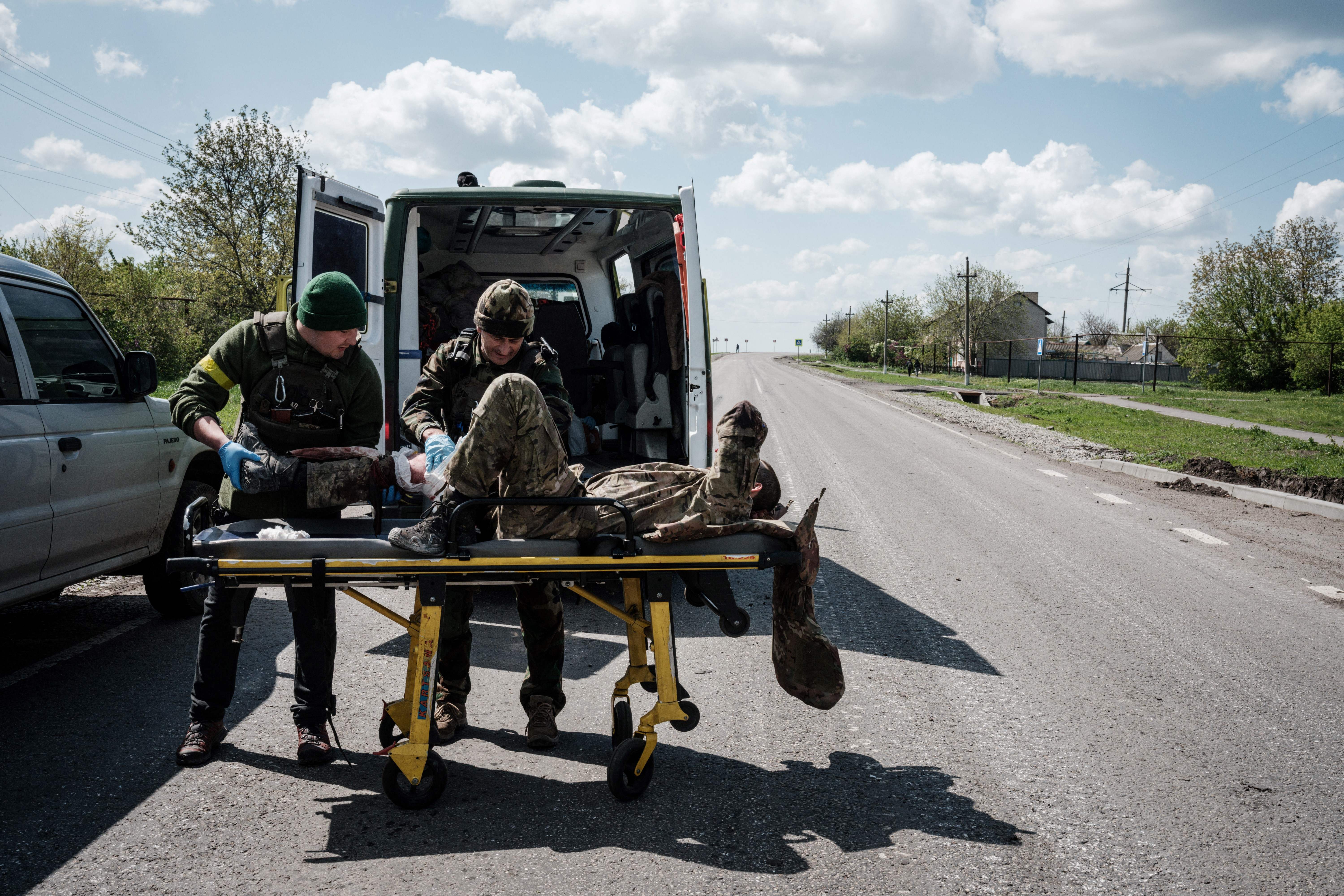 Members of the Ukrainian Army's mobile evacuation unit treat a soldier wounded on the frontline before his transfer to a hospital by ambulance, near Lysychansk, on May 10.