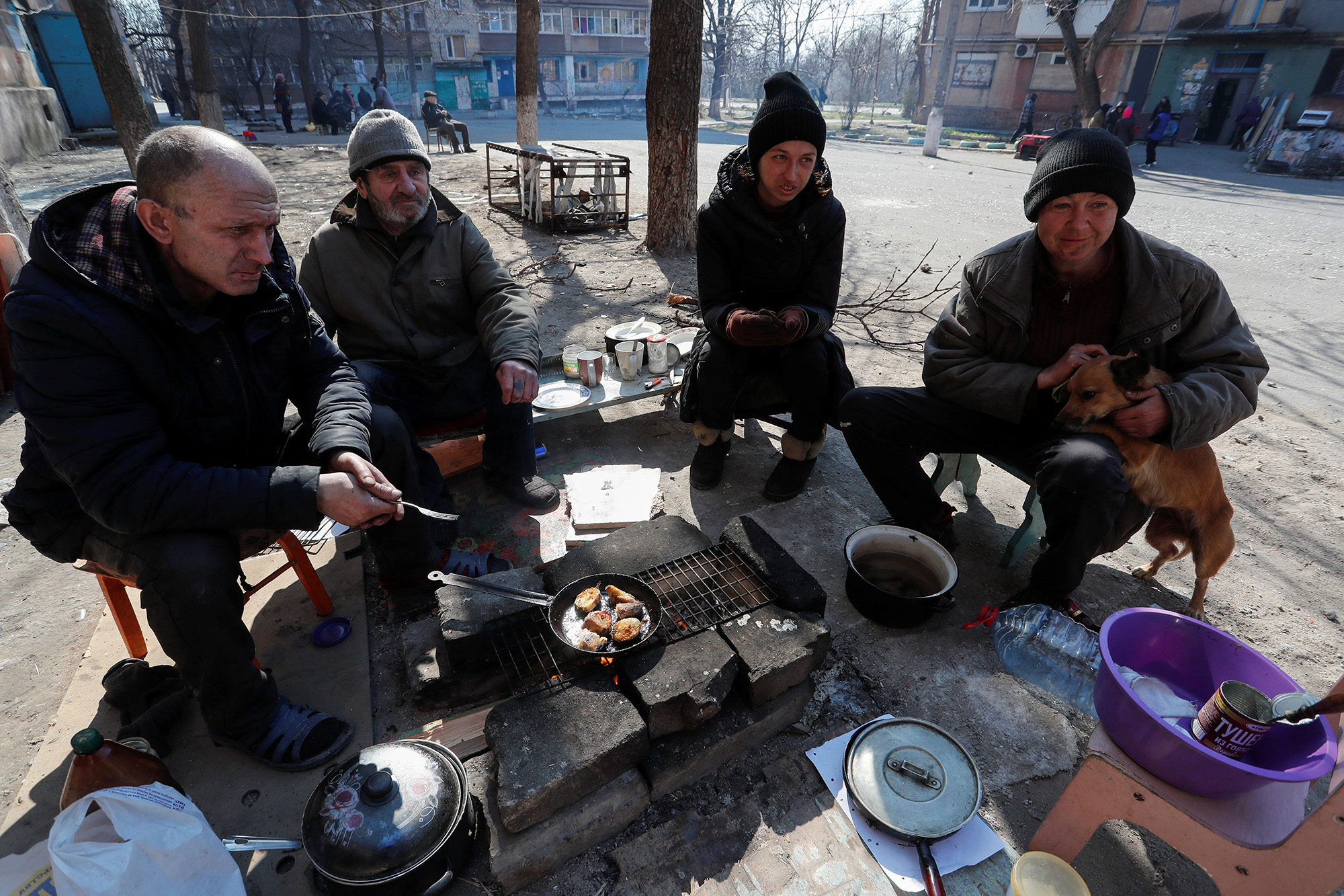 Local residents cook food in a courtyard in the southern port city of Mariupol, Ukraine, on April 5.