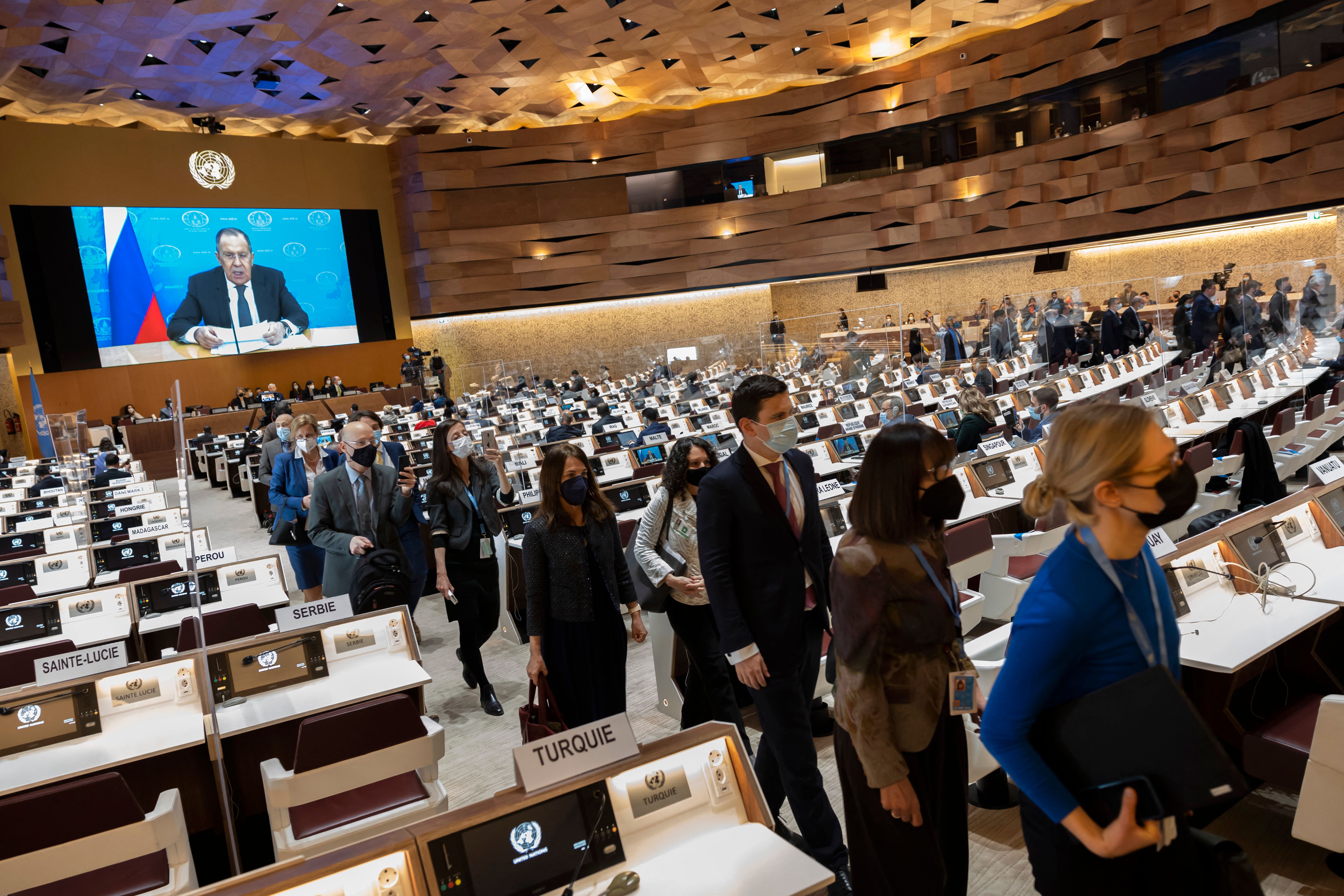 Ambassadors and diplomats leave while Russia's foreign minister Sergei Lavrov (on screen) addresses with a pre-recorded video message at the 49th session of the UN Human Rights Council at the European headquarters of the United Nations in Geneva, Switzerland, on March 1.