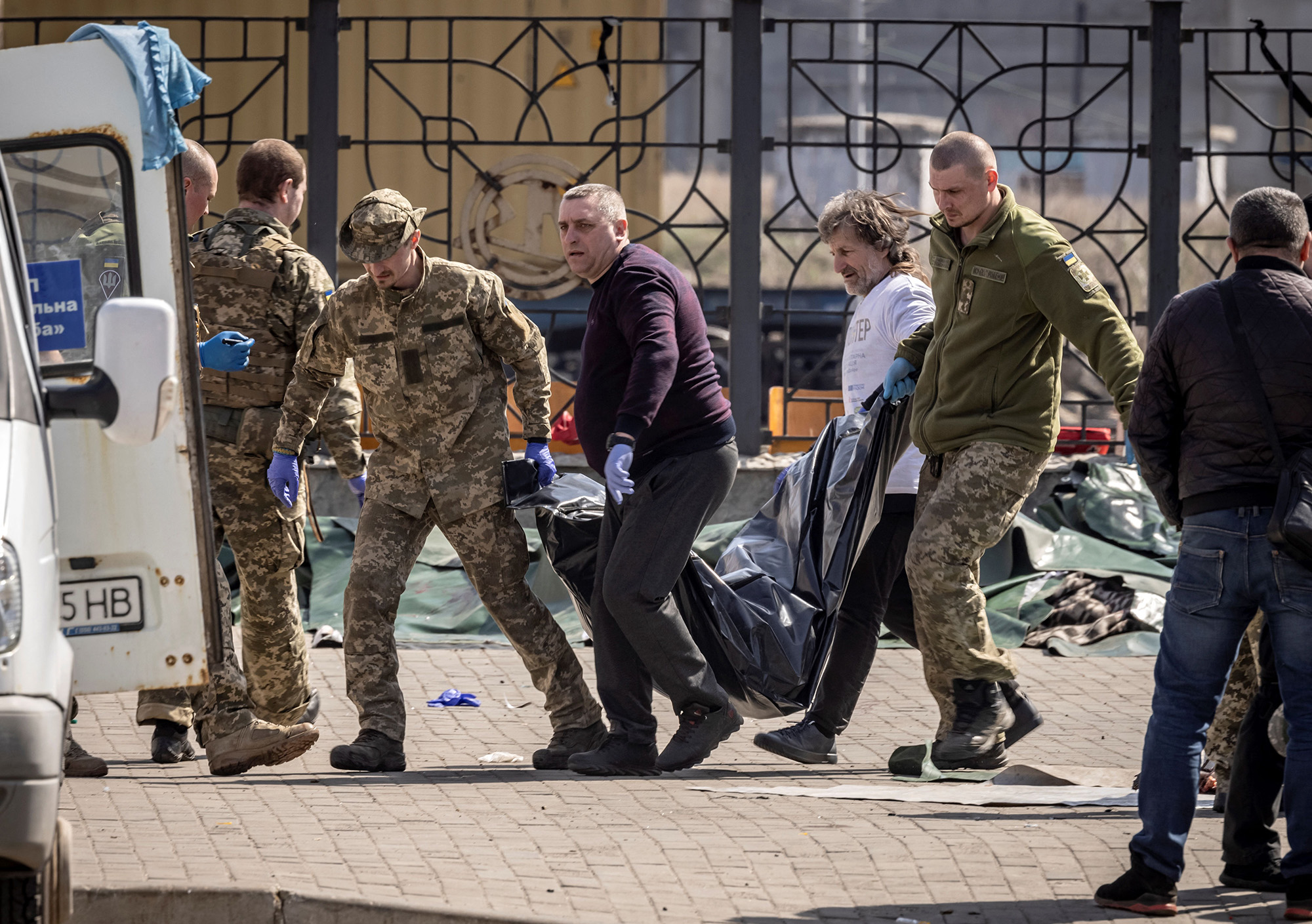 Ukrainian soldiers remove bodies after a rocket attack killed at a train station in Kramatorsk, Ukraine, on April 8, 2022.