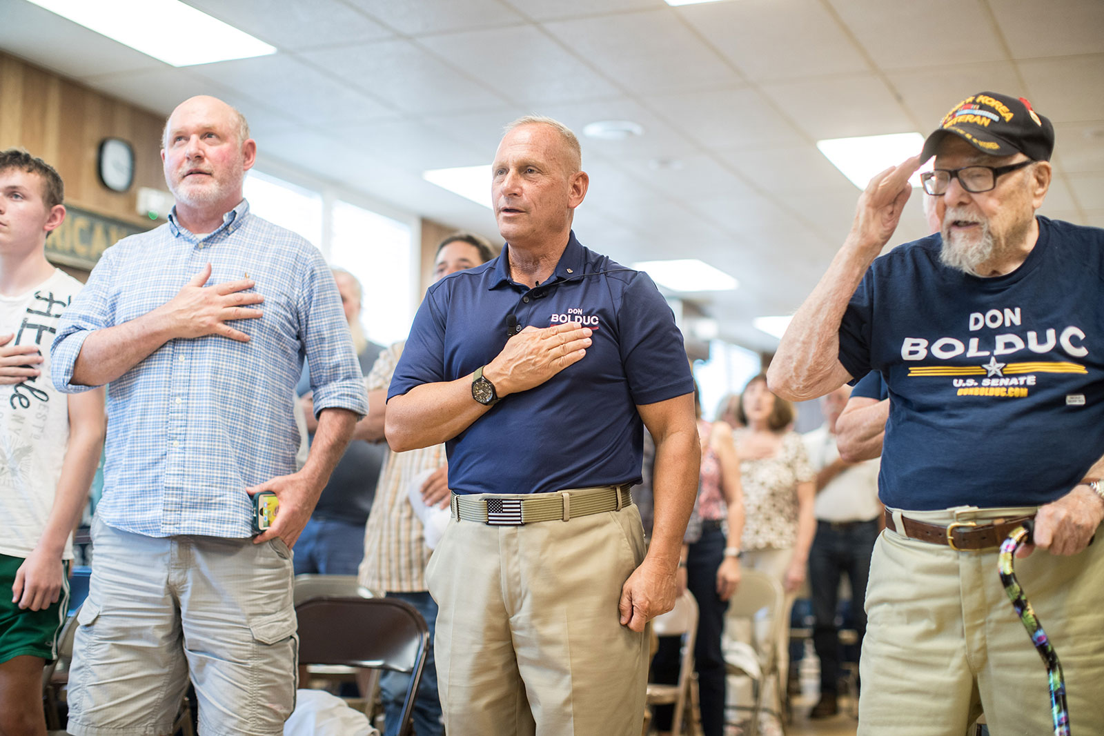 Don Bolduc, center, stands with supporters during the Pledge of Allegiance at a town hall event in Laconia, New Hampshire on September 10.