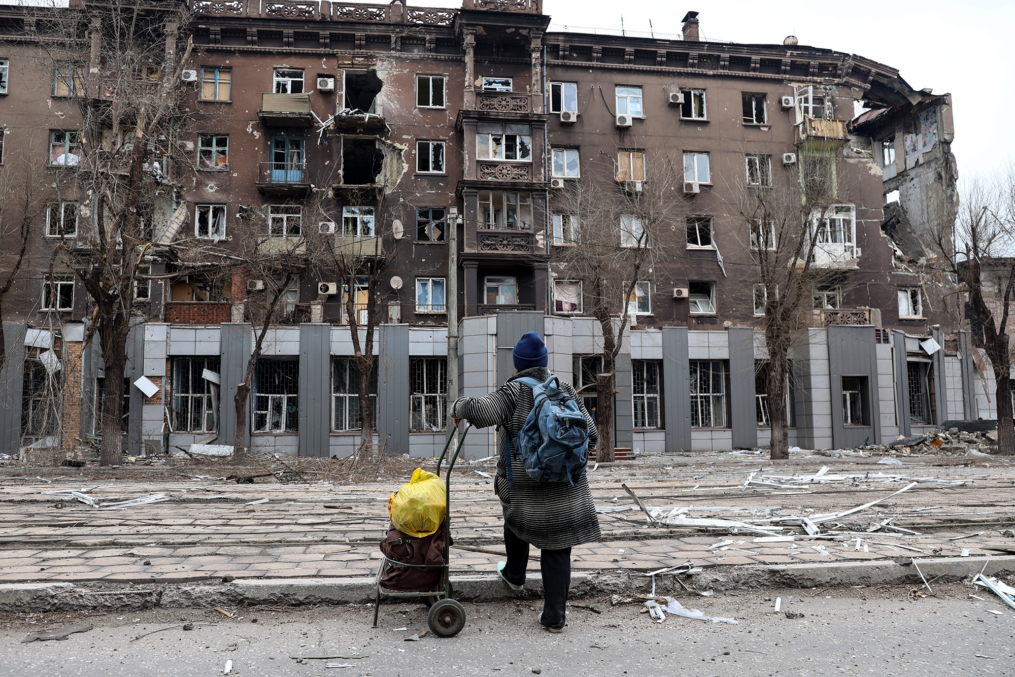 A resident looks at a building damaged during heavy fighting in Mariupol, Ukraine on April 16. 